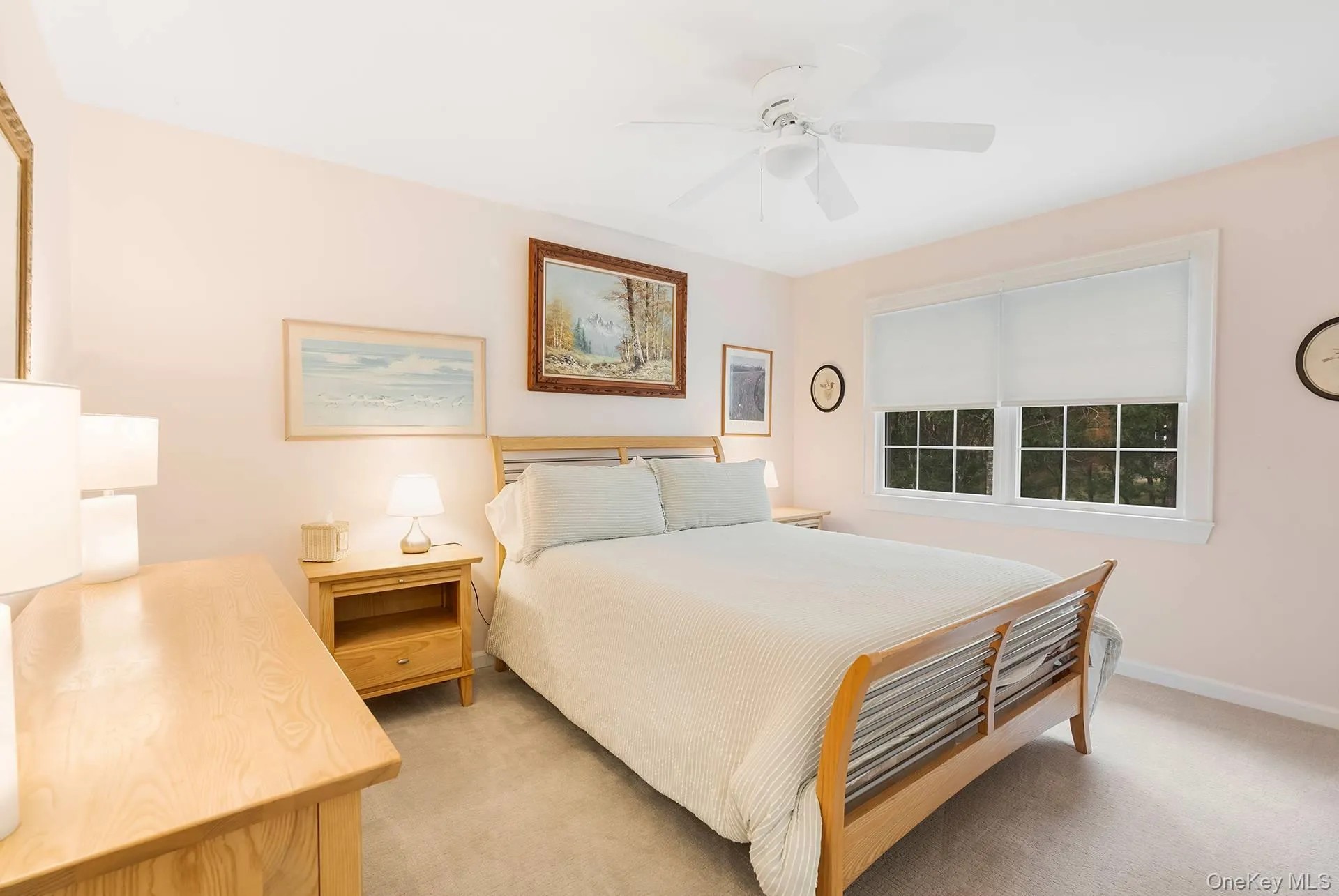 Bedroom featuring light carpet and ceiling fan Bedroom featuring light carpet and ceiling fan