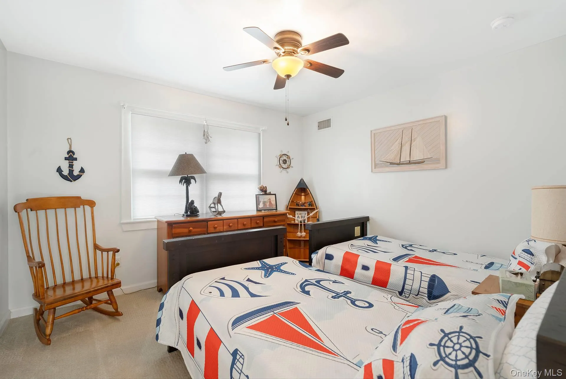 Bedroom with carpet flooring and a ceiling fan Bedroom with carpet flooring and a ceiling fan