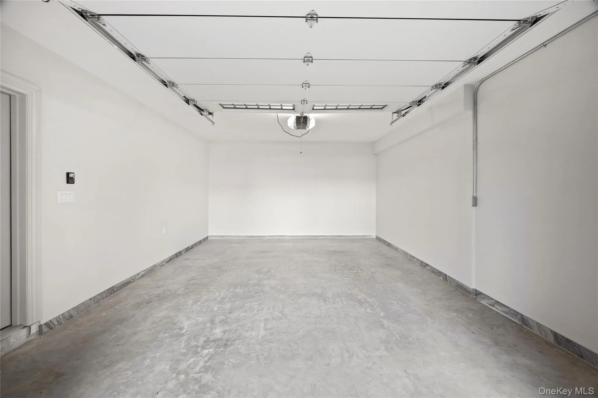 Garage featuring a garage door opener Garage featuring a garage door opener