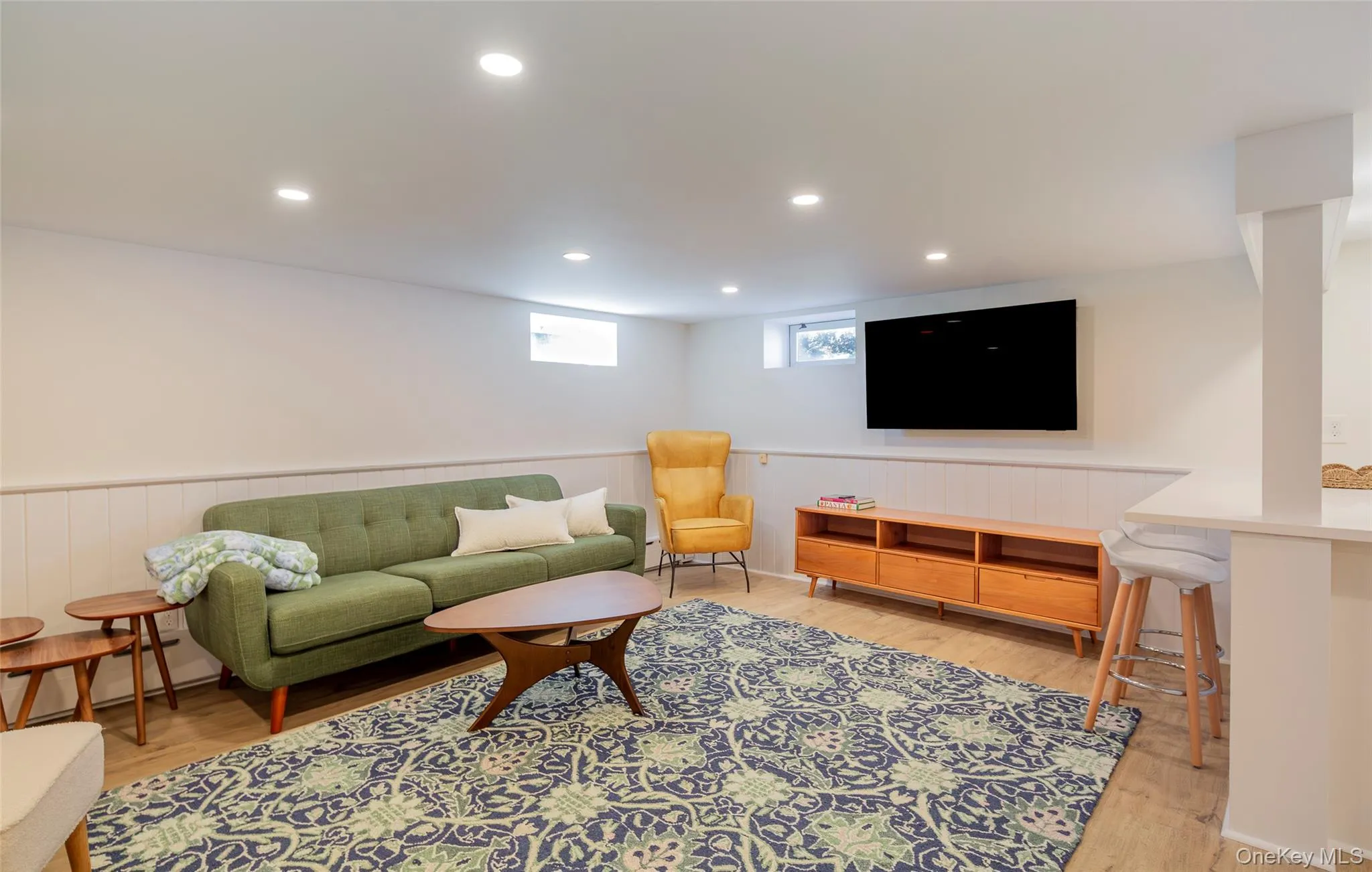 Living room with wainscoting, recessed lighting, and light wood finished floors Living room with wainscoting, recessed lighting, and light wood finished floors