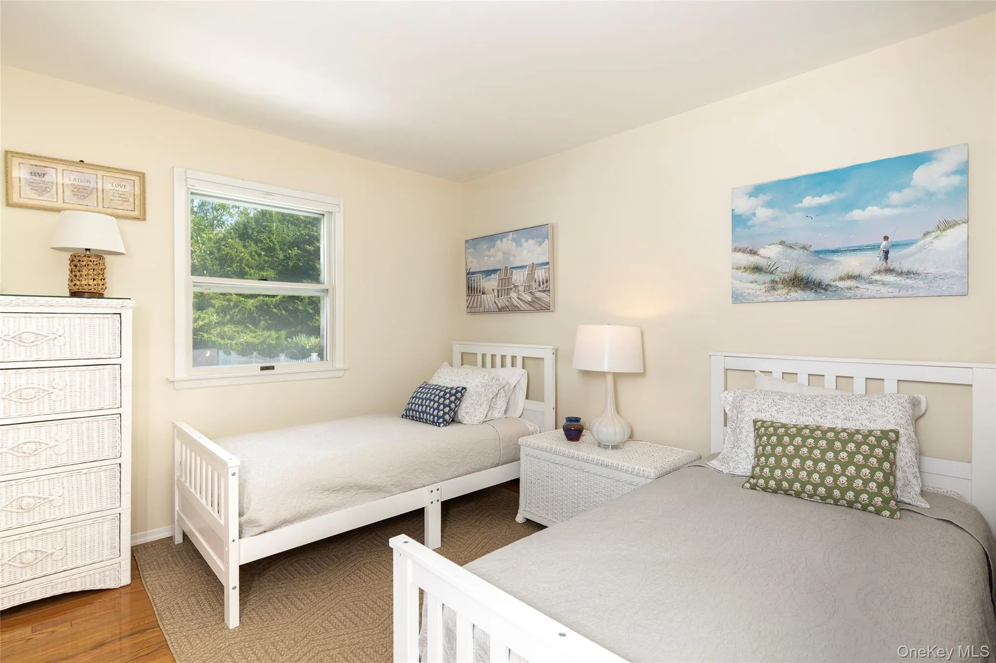 Bedroom featuring wood finished floors and baseboards Bedroom featuring wood finished floors and baseboards