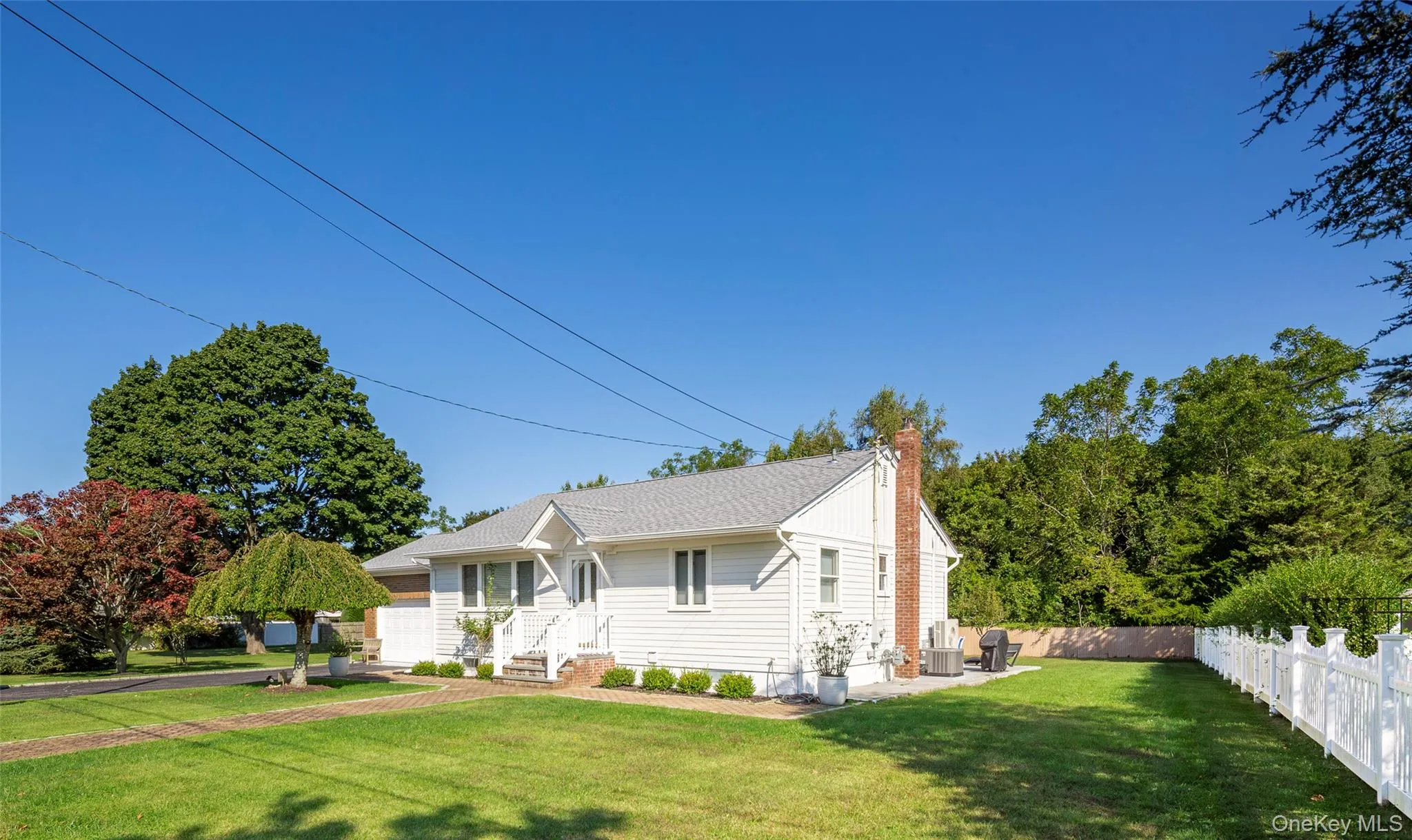 View of front of house featuring a fenced backyard and a chimney View of front of house featuring a fenced backyard and a chimney