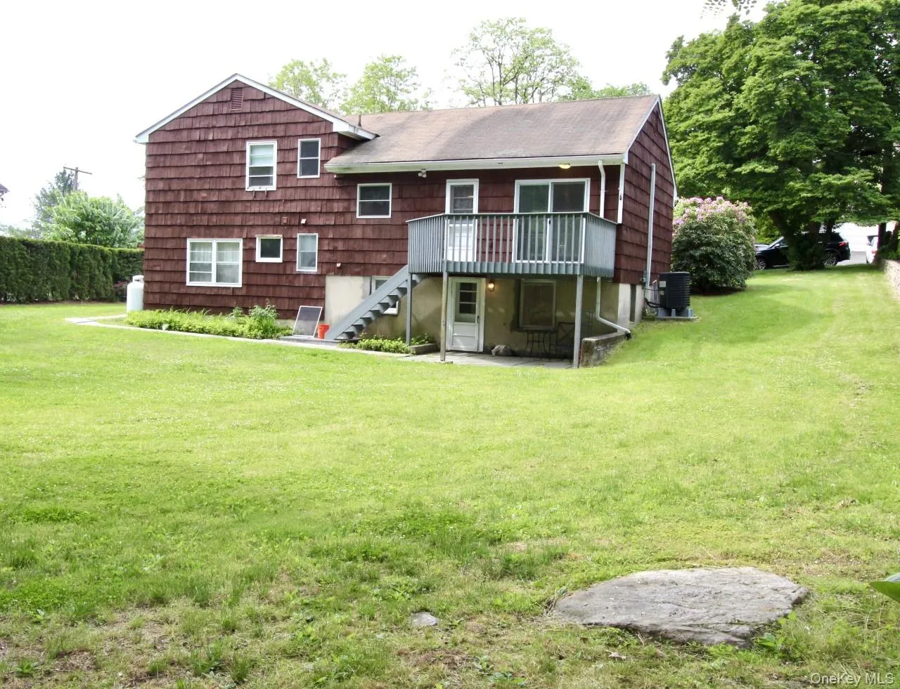 Back of house with stairway, a patio area, a yard, and a deck Back of house with stairway, a patio area, a yard, and a deck