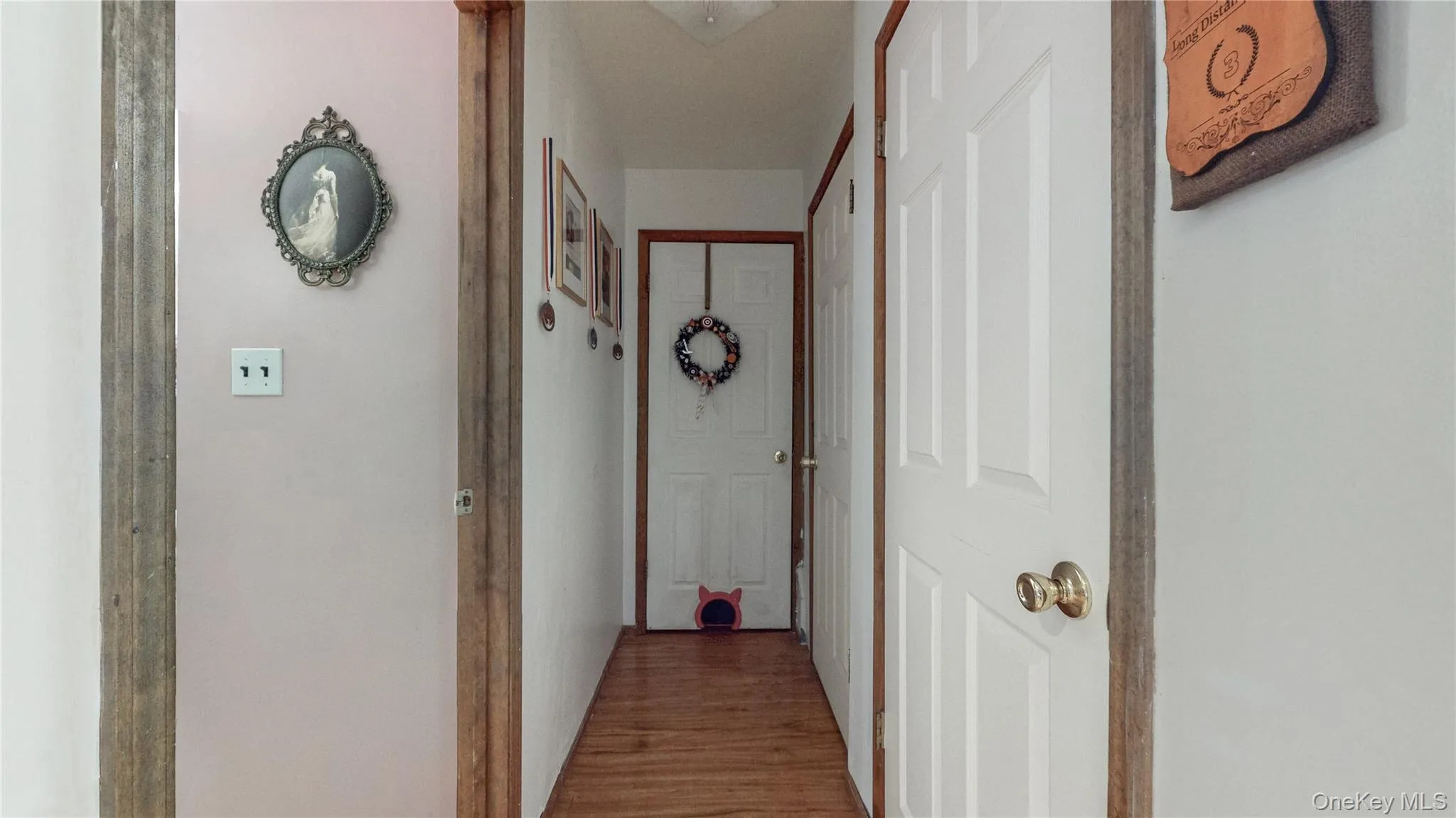 Hall featuring wood finished floors Hall featuring wood finished floors