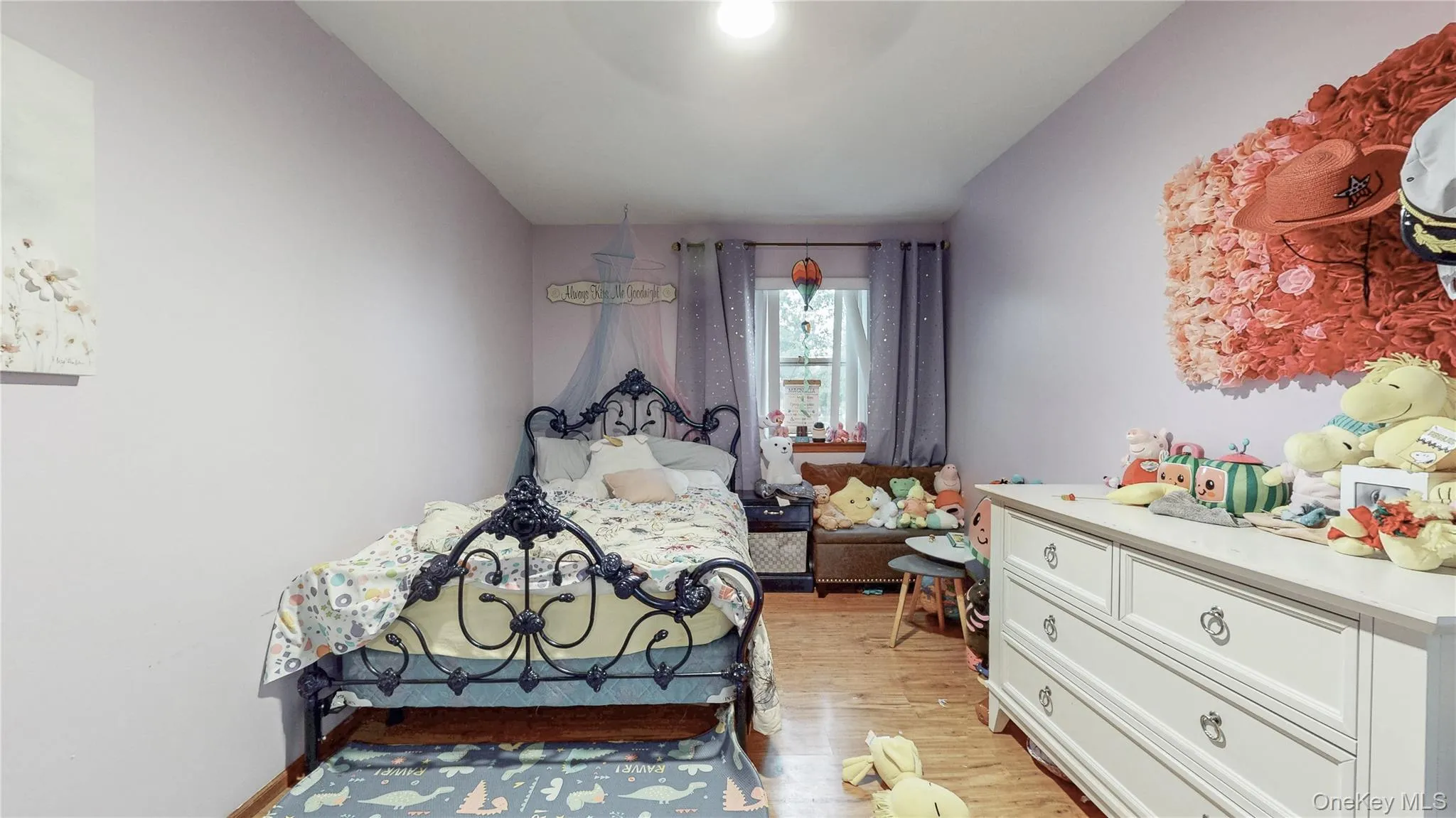 Bedroom with light wood-type flooring and baseboards Bedroom with light wood-type flooring and baseboards