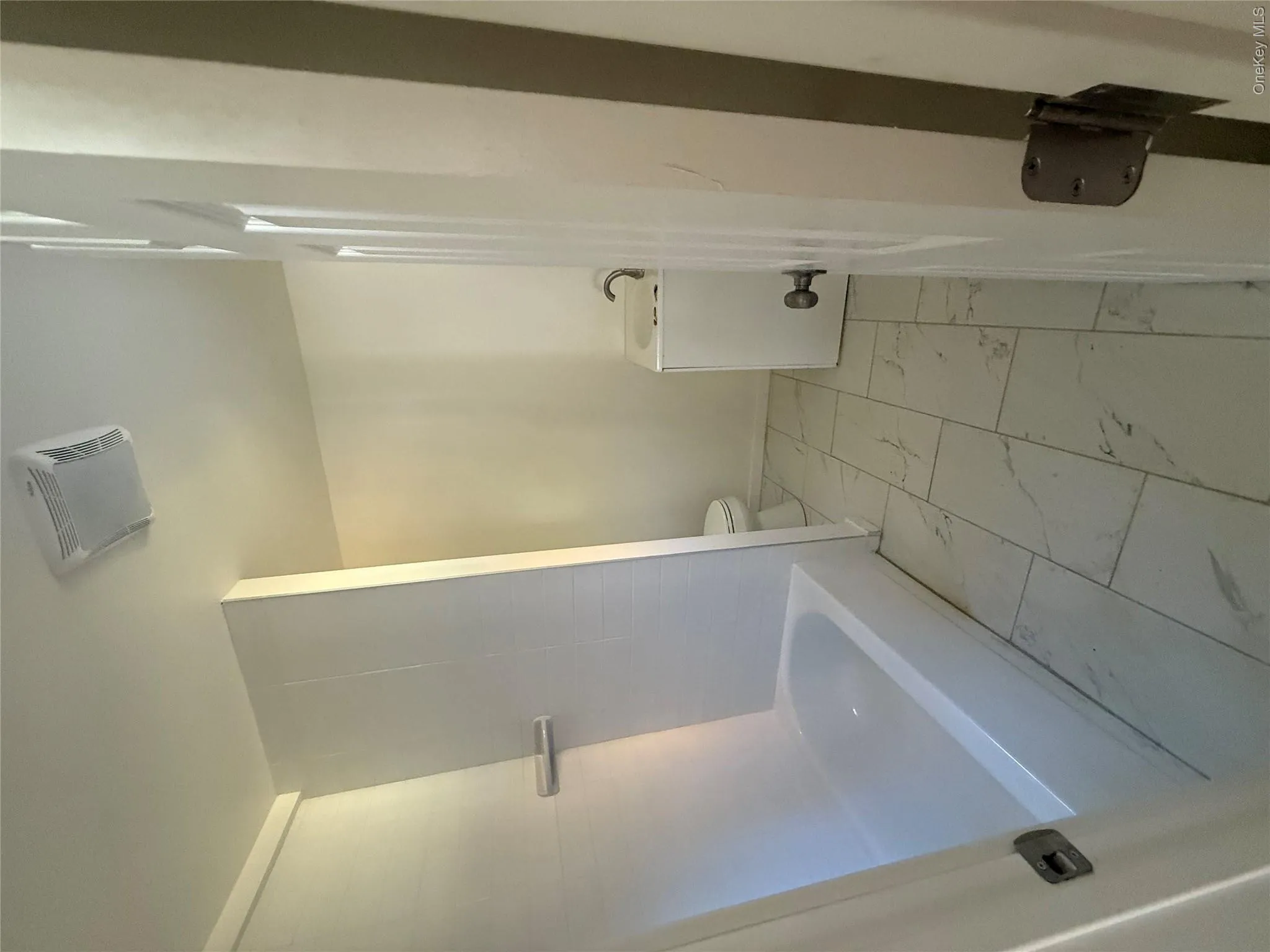Full bathroom featuring vanity, light marble finish flooring, and bathtub / shower combination Full bathroom featuring vanity, light marble finish flooring, and bathtub / shower combination