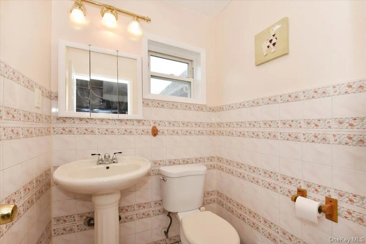 Bathroom with wainscoting and tile walls Bathroom with wainscoting and tile walls