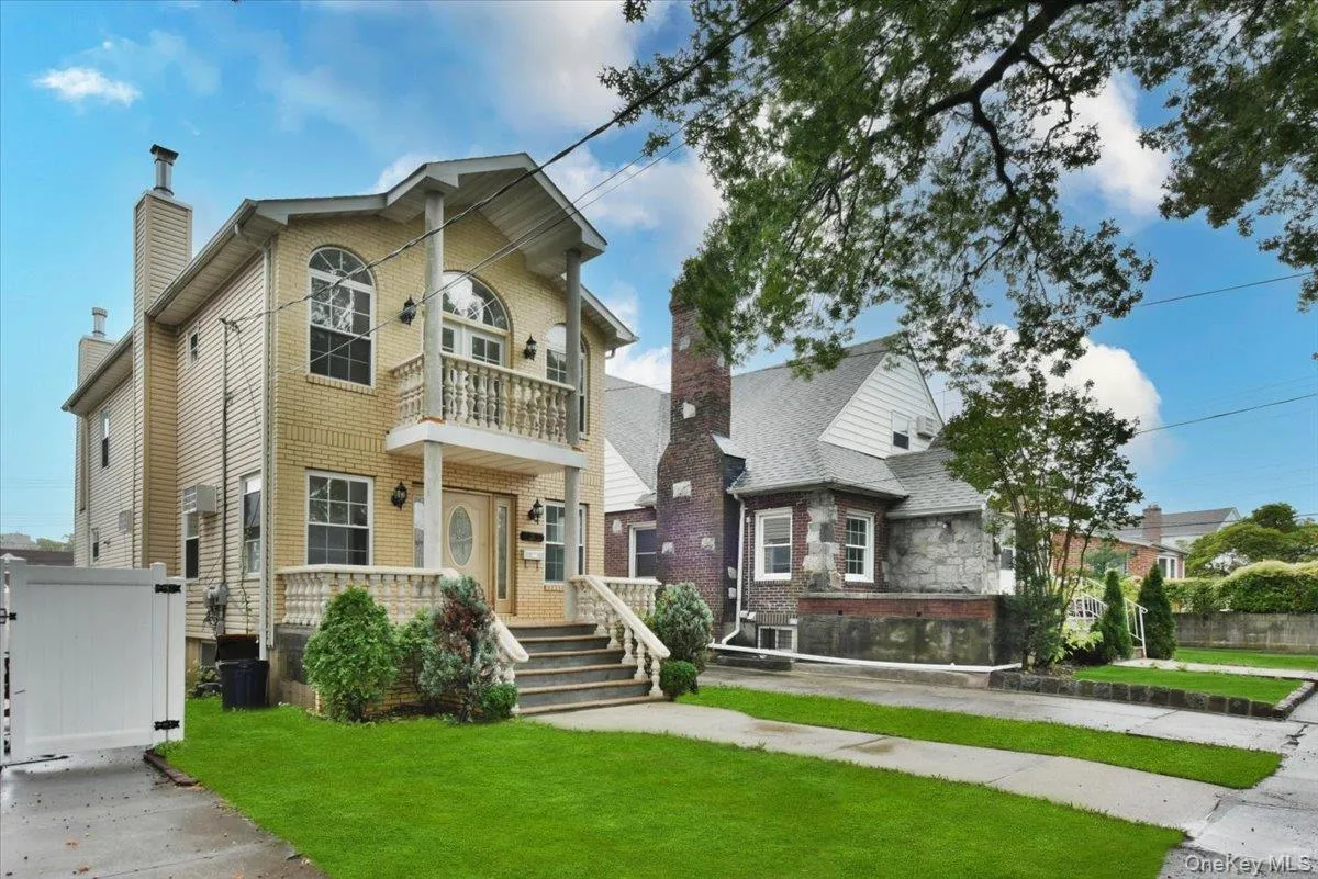View of front of house with a balcony and a chimney View of front of house with a balcony and a chimney
