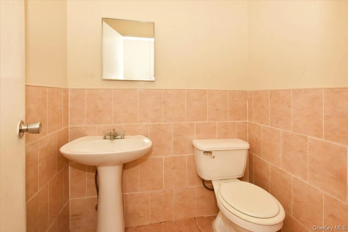 Bathroom with tile walls, wainscoting, and tile patterned floors Bathroom with tile walls, wainscoting, and tile patterned floors