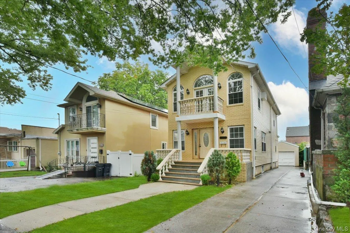 View of front of home featuring a balcony, a detached garage, and an outdoor structure View of front of home featuring a balcony, a detached garage, and an outdoor structure
