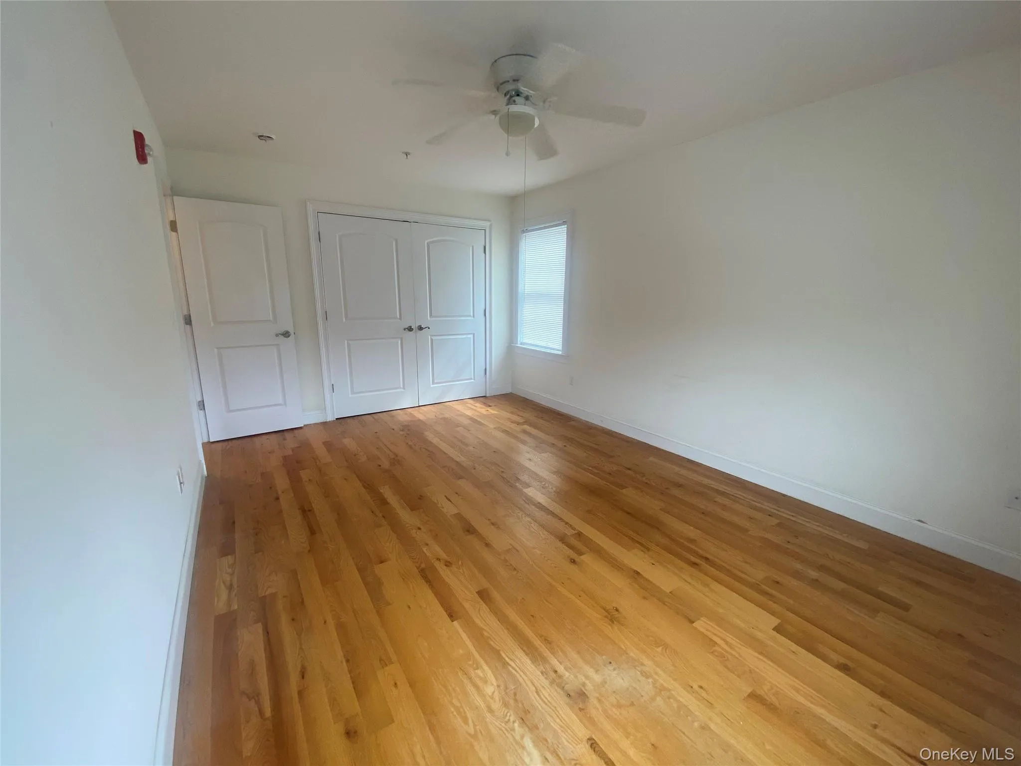 Unfurnished bedroom featuring light wood-style floors, a ceiling fan, and a closet Unfurnished bedroom featuring light wood-style floors, a ceiling fan, and a closet