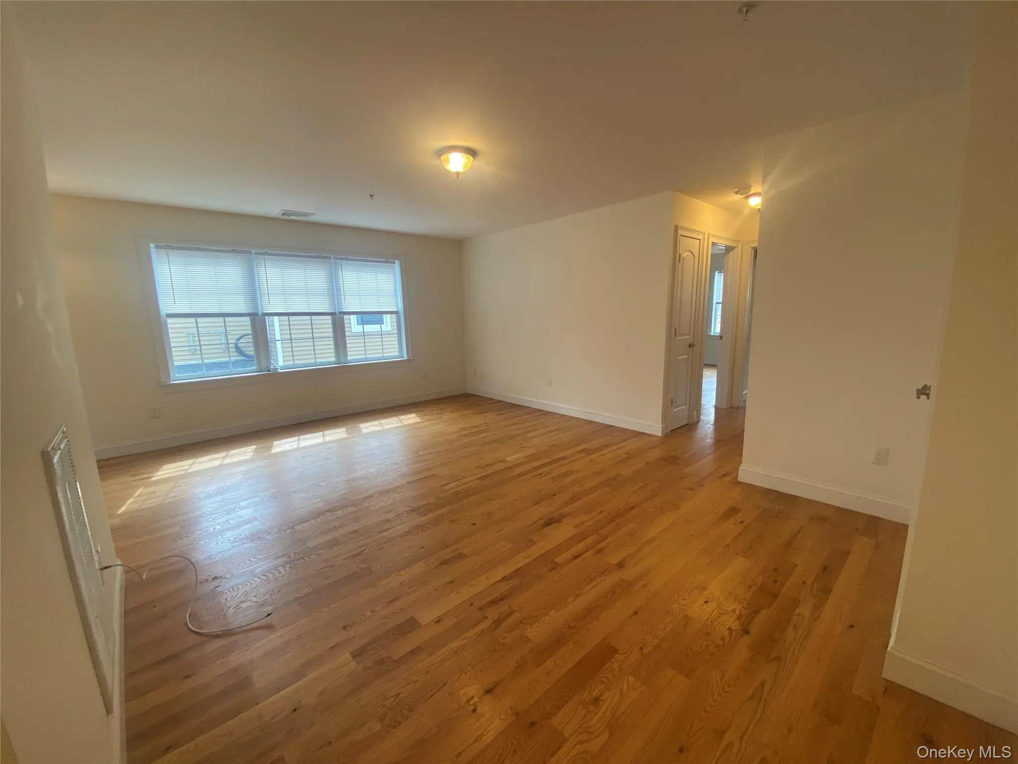 Unfurnished room with light wood-type flooring and baseboards Unfurnished room with light wood-type flooring and baseboards
