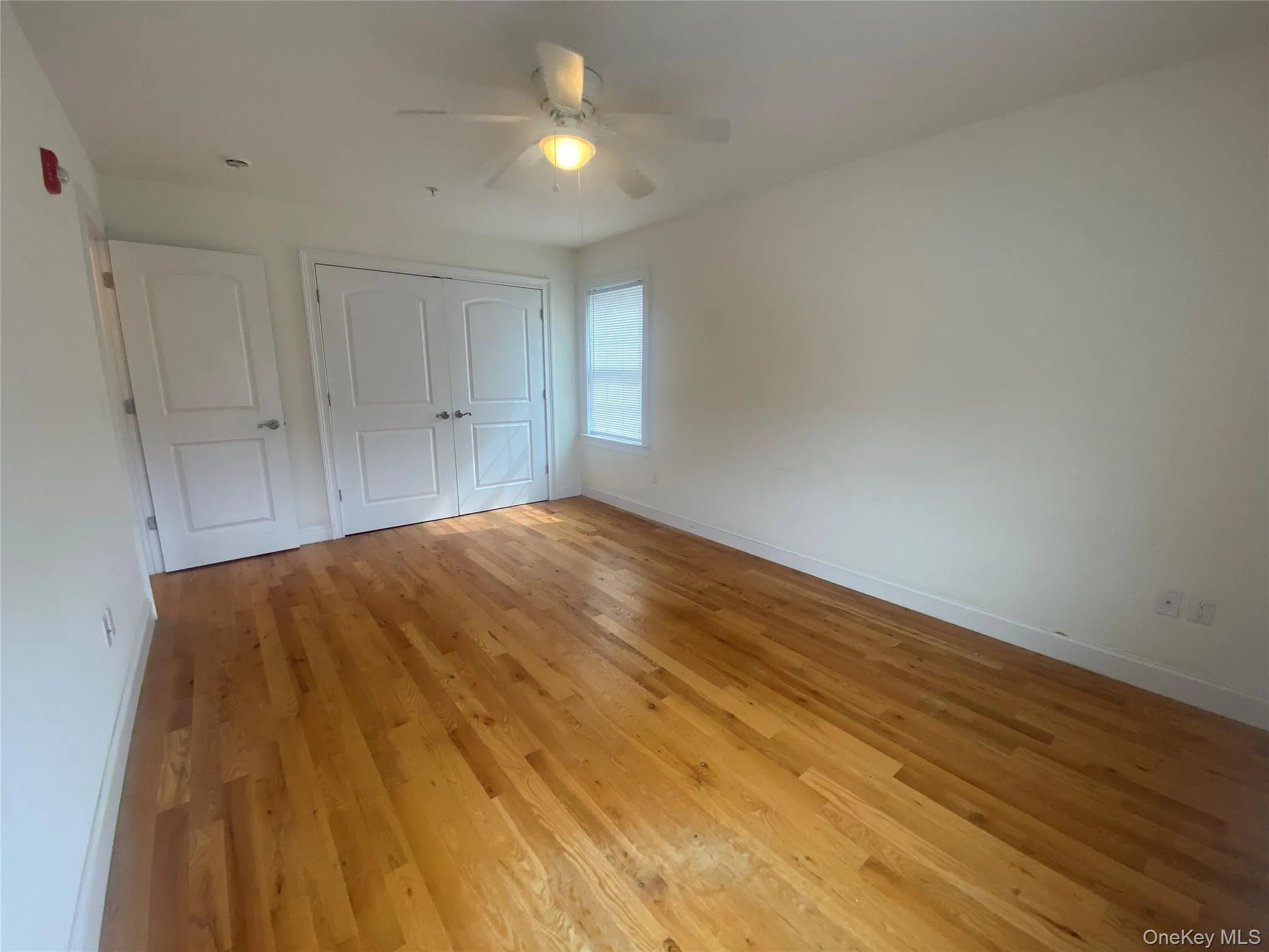 Unfurnished bedroom with light wood-style flooring, ceiling fan, and a closet Unfurnished bedroom with light wood-style flooring, ceiling fan, and a closet