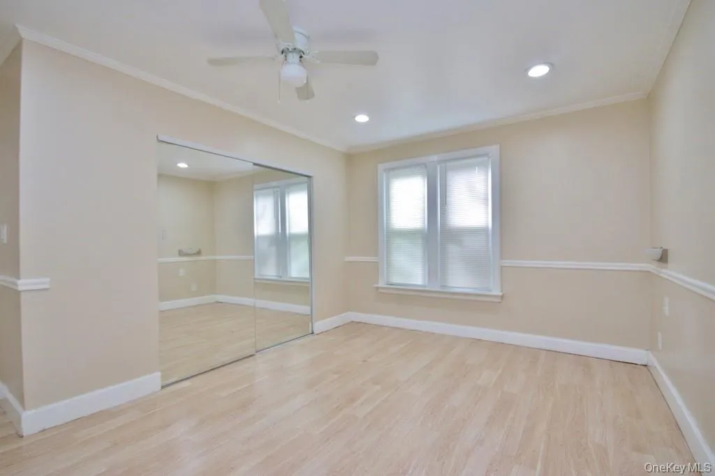 Unfurnished room with light wood finished floors, ornamental molding, recessed lighting, and ceiling fan Unfurnished room with light wood finished floors, ornamental molding, recessed lighting, and ceiling fan