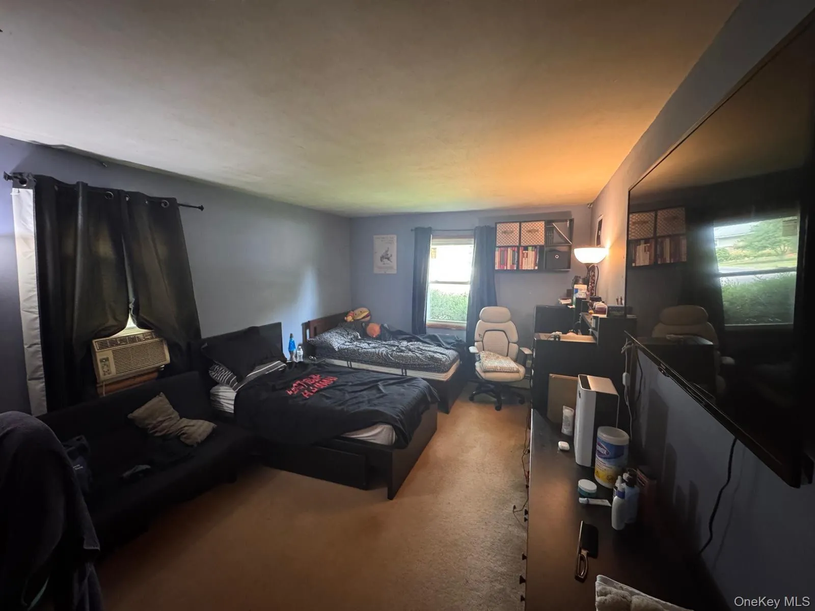 Bedroom with carpet, cooling unit, and a desk Bedroom with carpet, cooling unit, and a desk