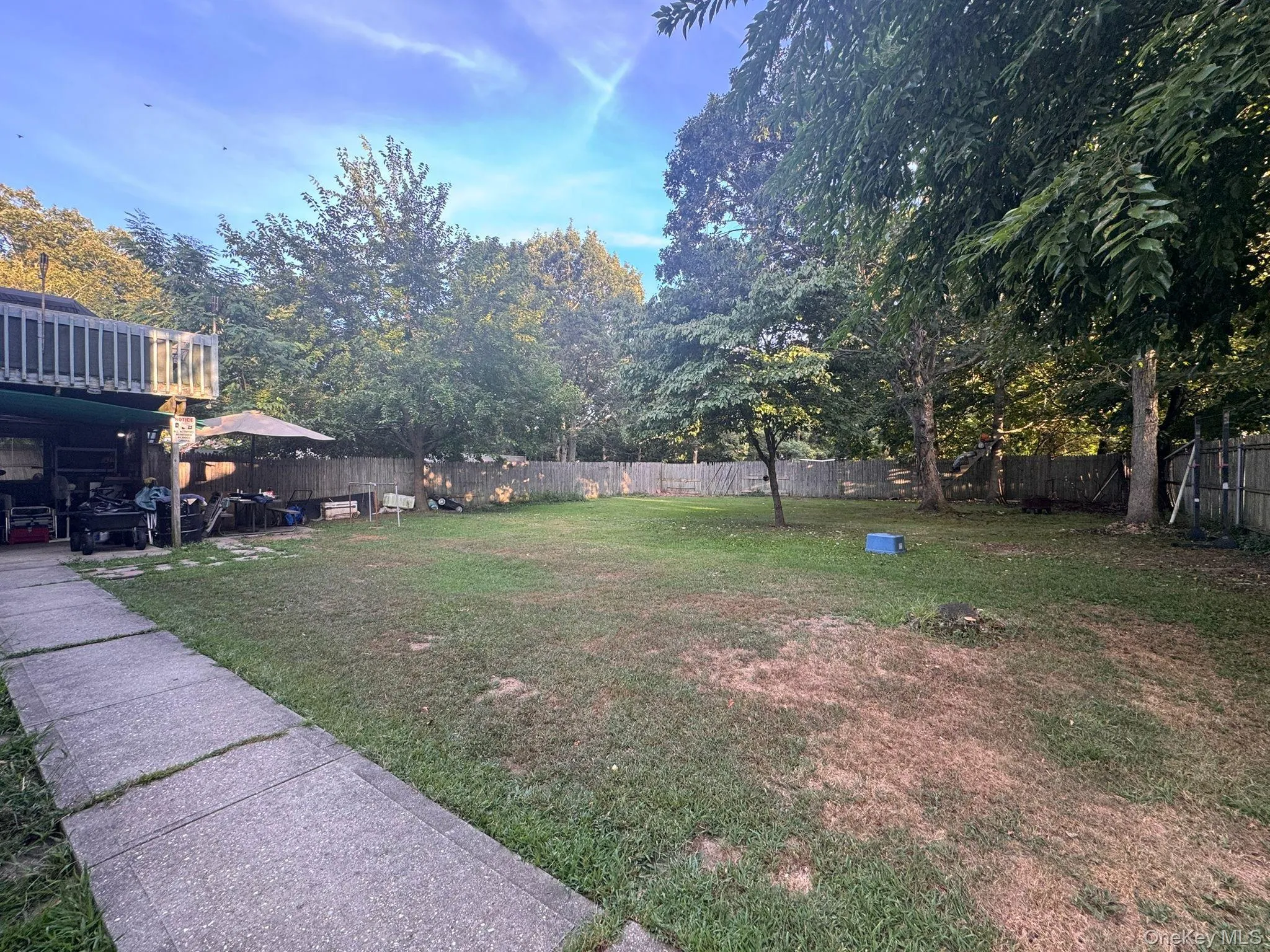 Fenced backyard with a patio area Fenced backyard with a patio area