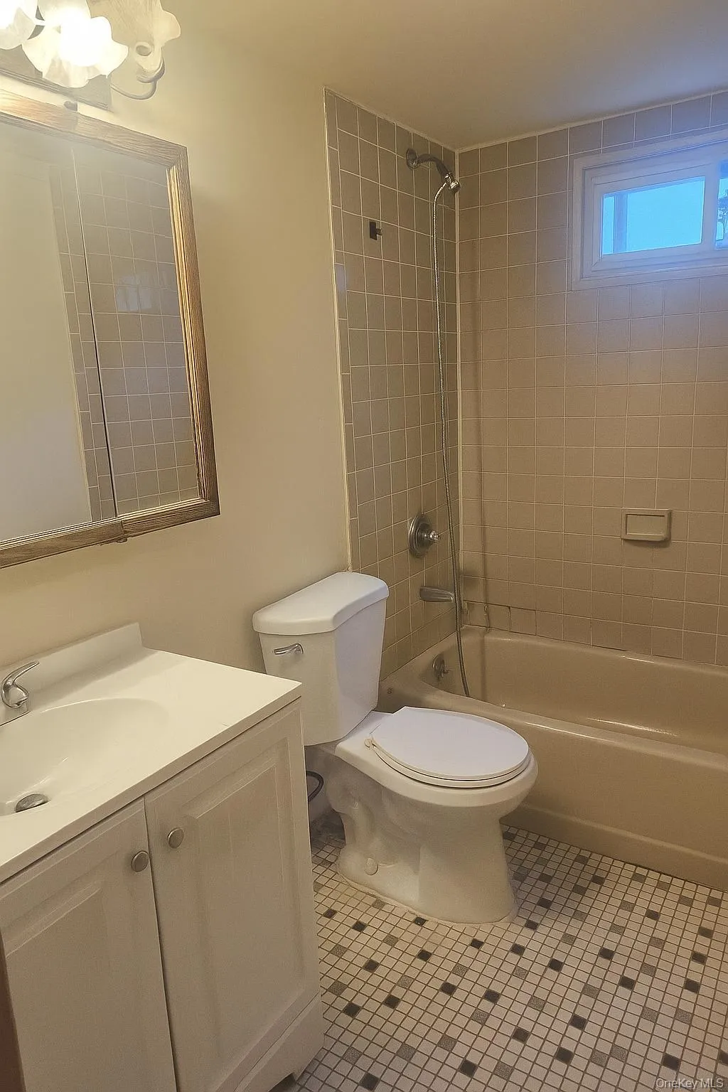 Full bath with tub / shower combination, vanity, and light tile patterned floors Full bath with tub / shower combination, vanity, and light tile patterned floors