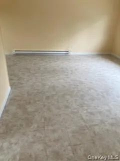 Empty room with baseboards and baseboard heating Empty room with baseboards and baseboard heating