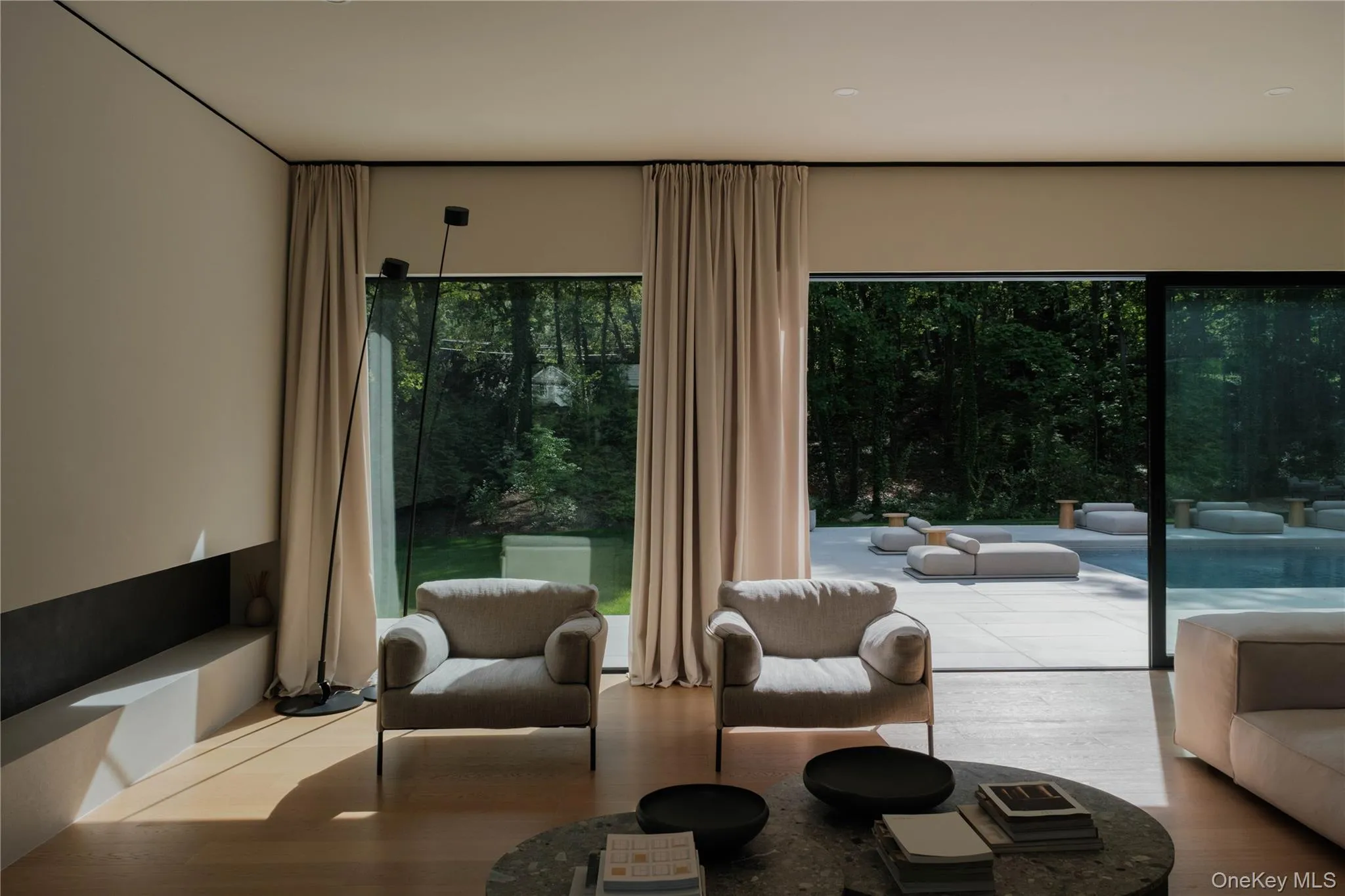 Living room with floor to ceiling marvin windows view to the backyard Living room with floor to ceiling marvin windows view to the backyard
