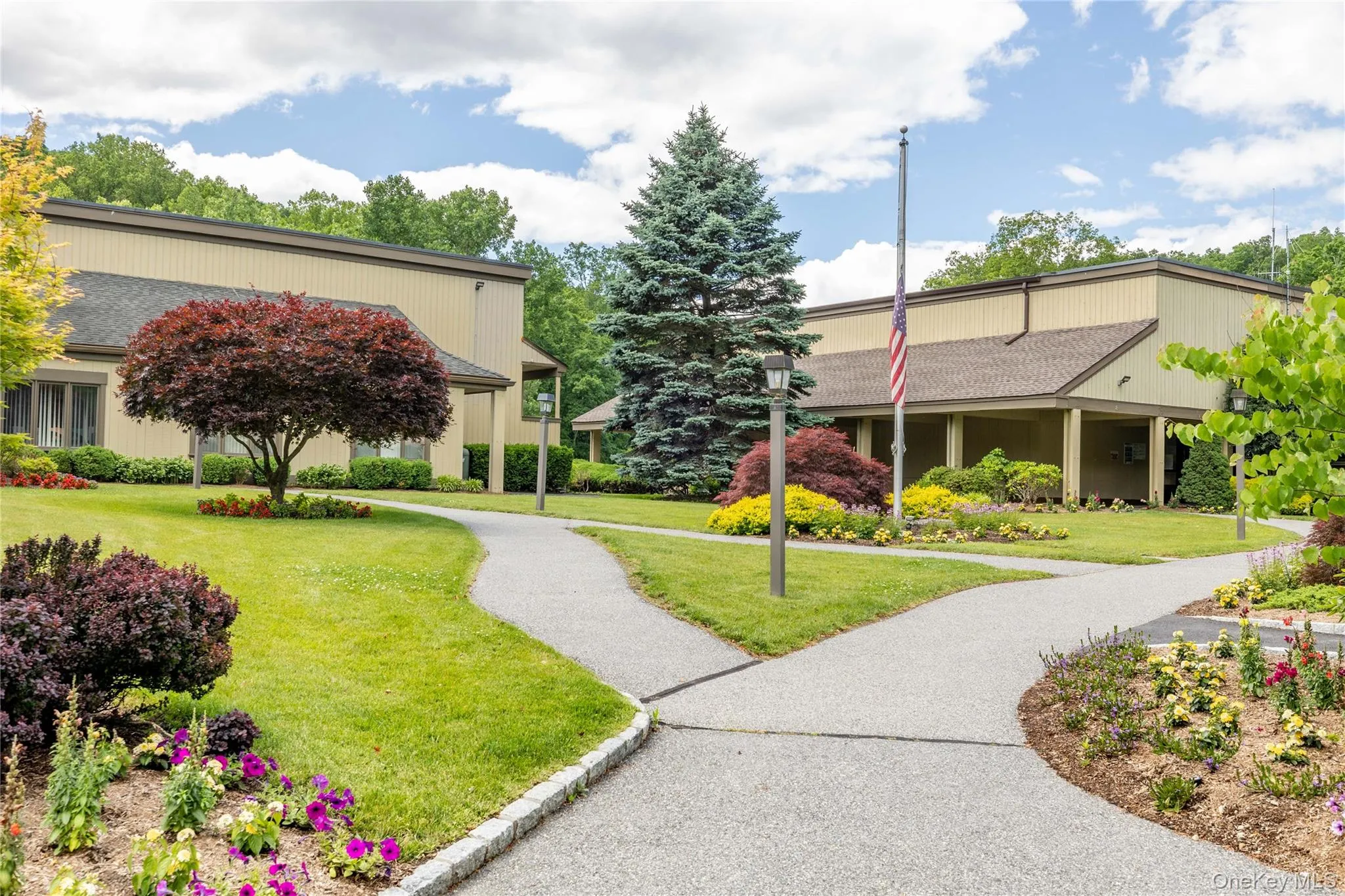Community Center. View of community featuring a lawn Community Center. View of community featuring a lawn