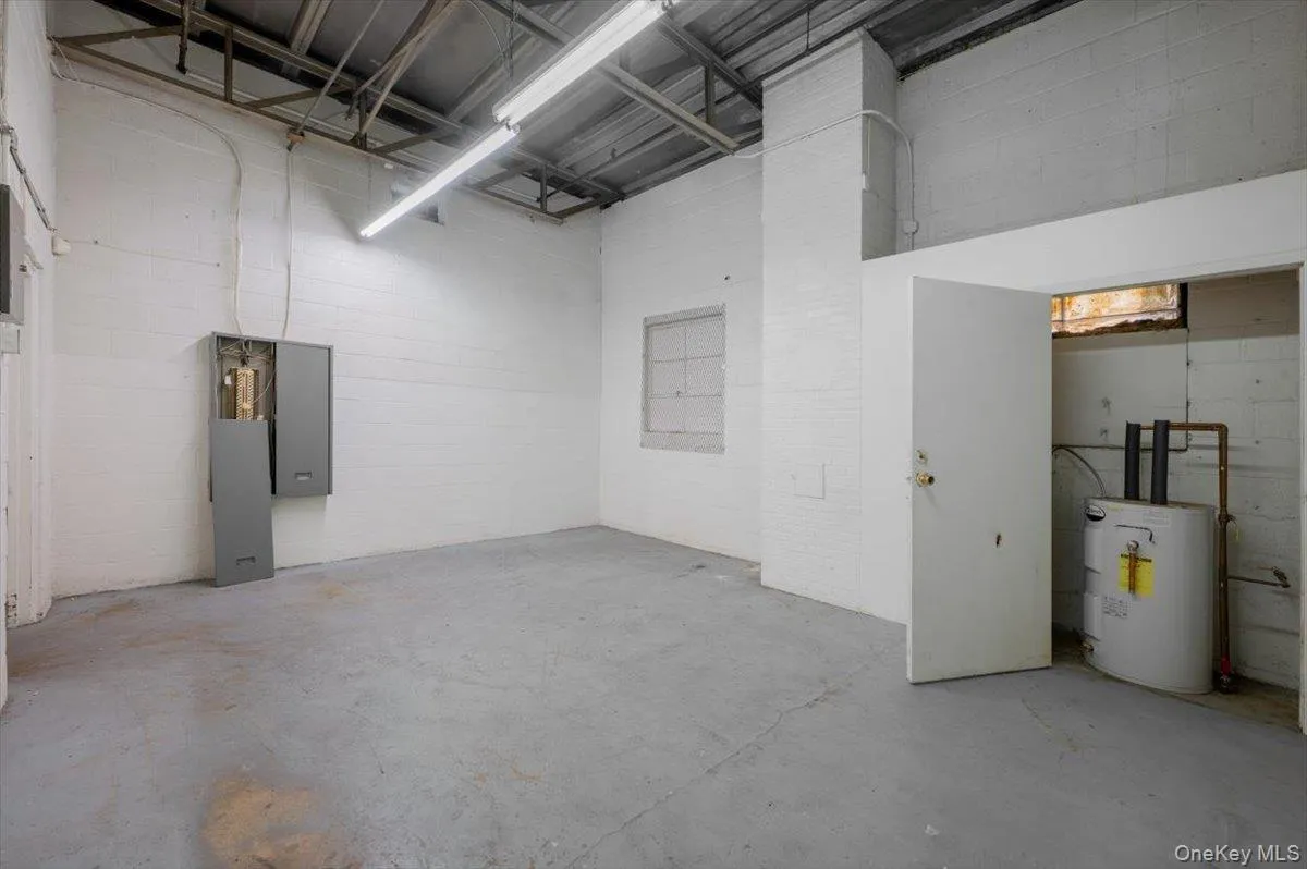 Room with electric water heater and concrete block wall Room with electric water heater and concrete block wall