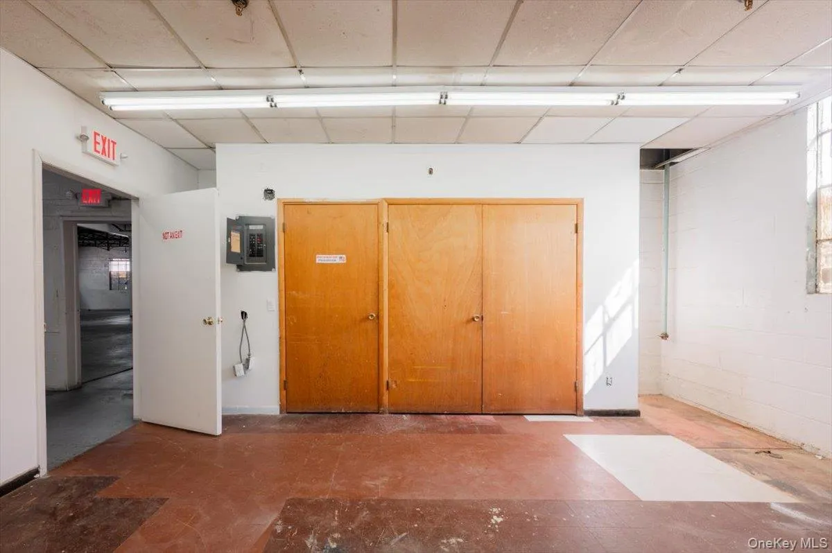 Corridor featuring electric panel and concrete block wall Corridor featuring electric panel and concrete block wall