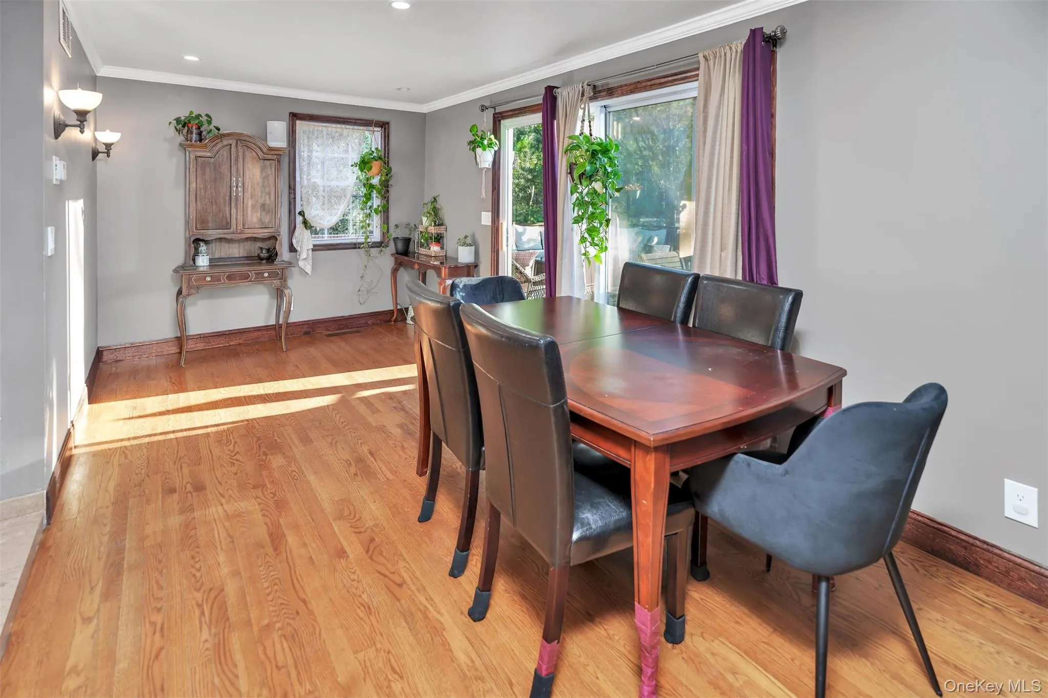 Dining space with light wood-type flooring, ornamental molding, and recessed lighting Dining space with light wood-type flooring, ornamental molding, and recessed lighting
