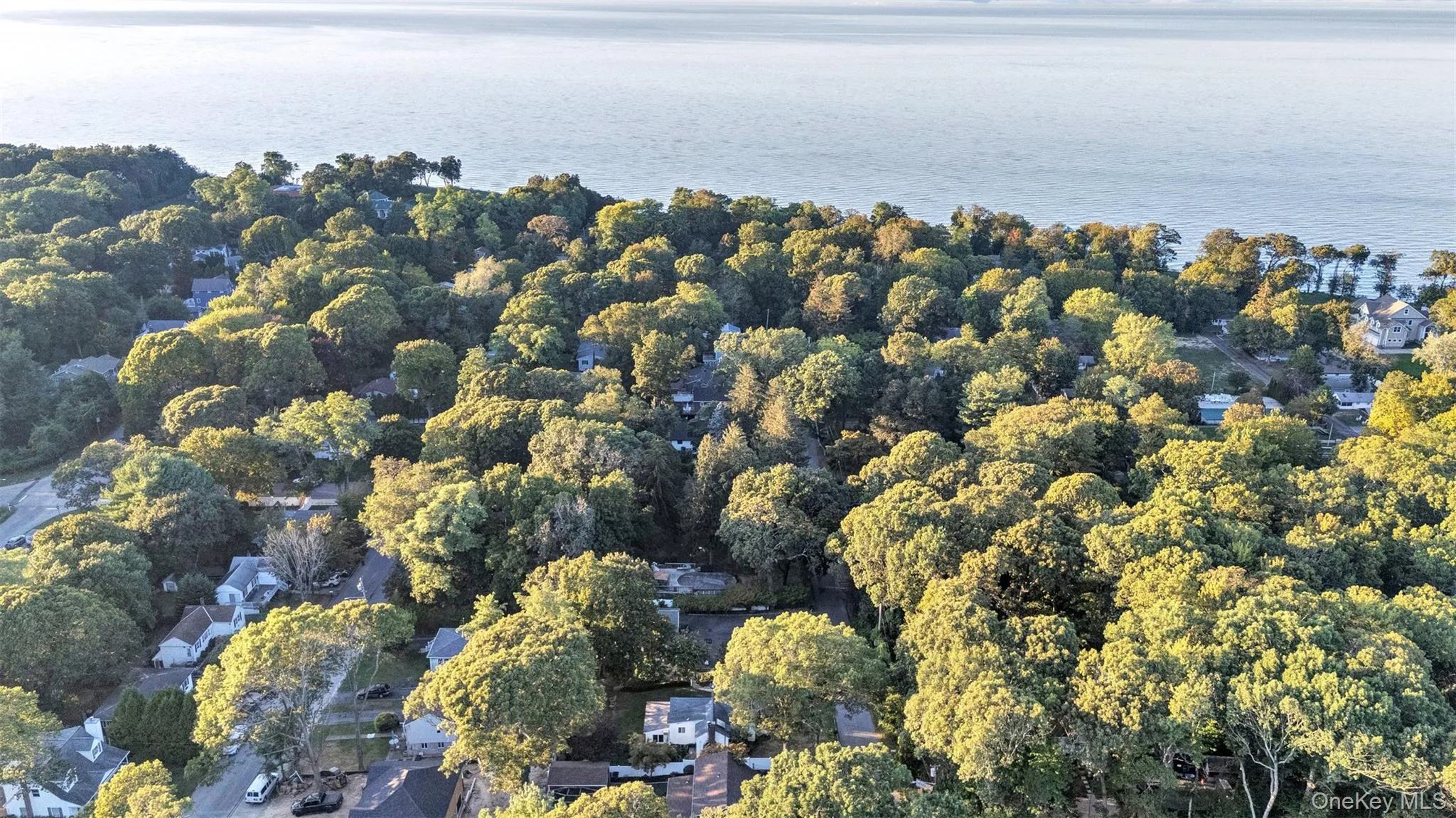 Aerial view of property's location with a nearby body of water Aerial view of property's location with a nearby body of water