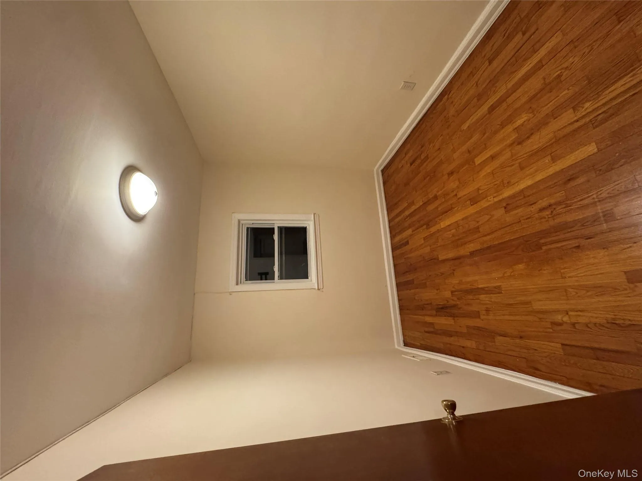 Unfurnished room with light wood finished floors and baseboards Unfurnished room with light wood finished floors and baseboards