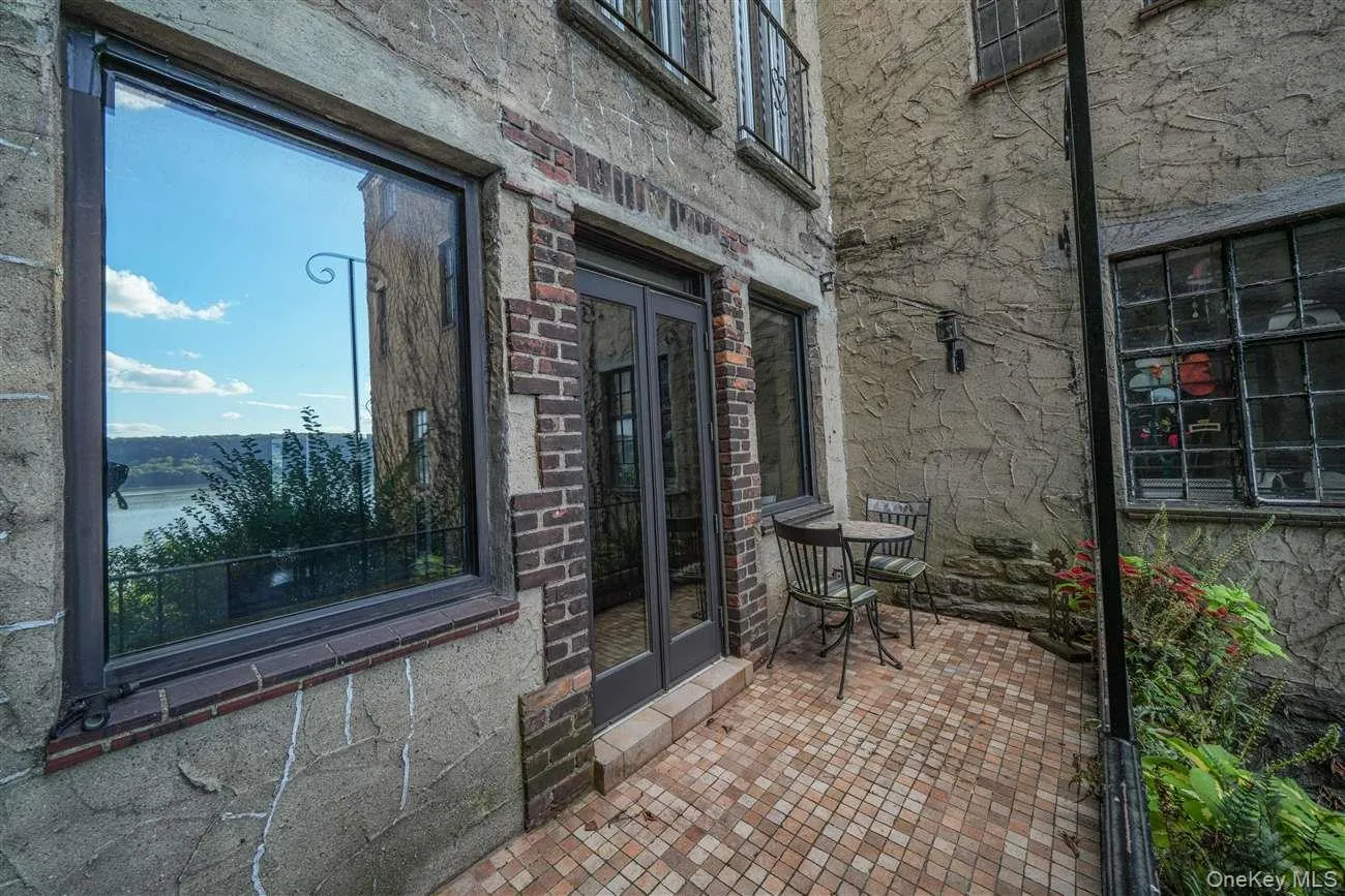 View of patio featuring french doors and a water view View of patio featuring french doors and a water view