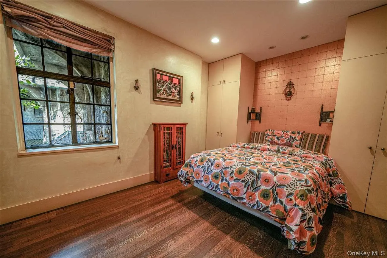Bedroom with dark wood-style floors, a closet, and recessed lighting Bedroom with dark wood-style floors, a closet, and recessed lighting