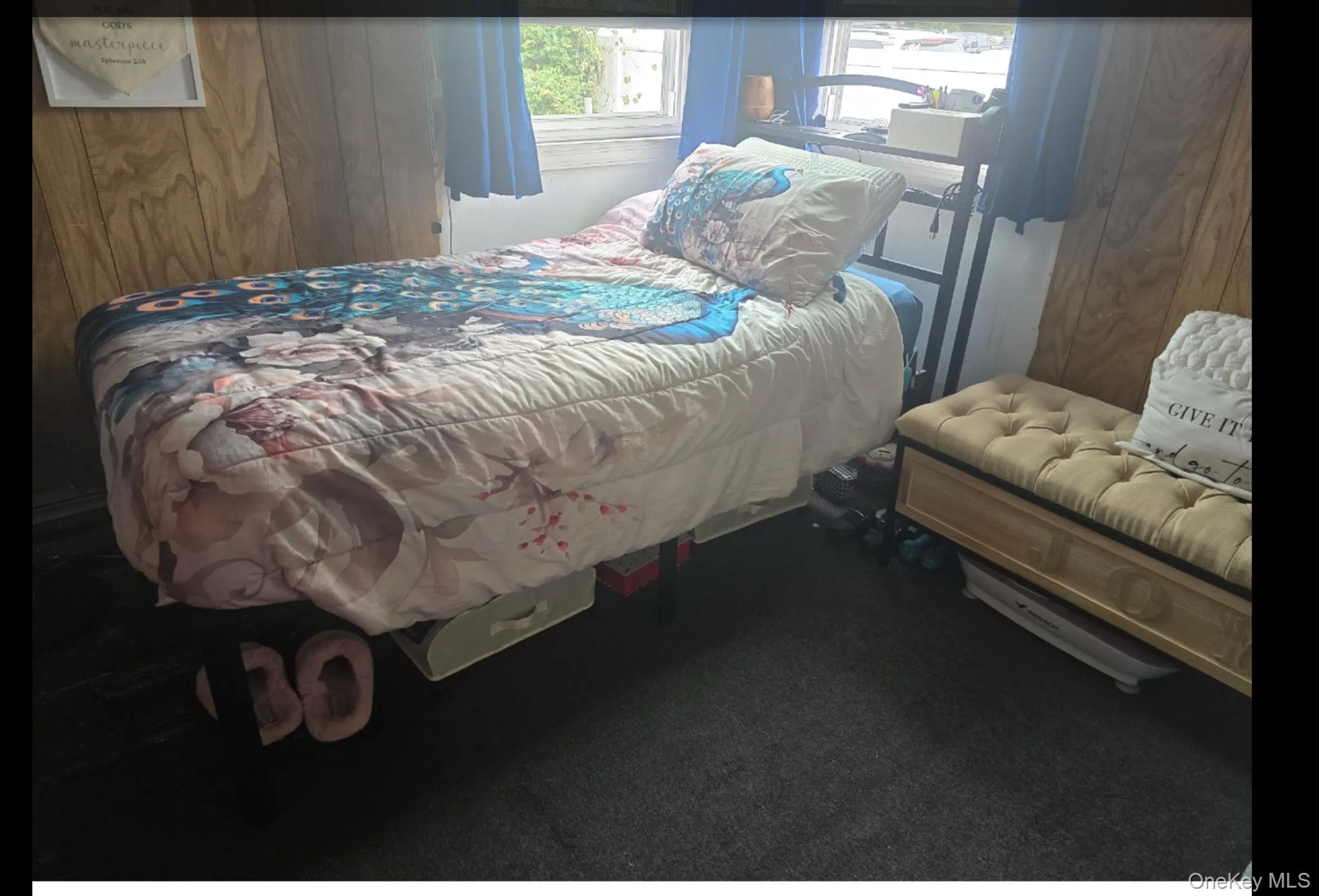 Bedroom featuring dark carpet and wooden walls Bedroom featuring dark carpet and wooden walls
