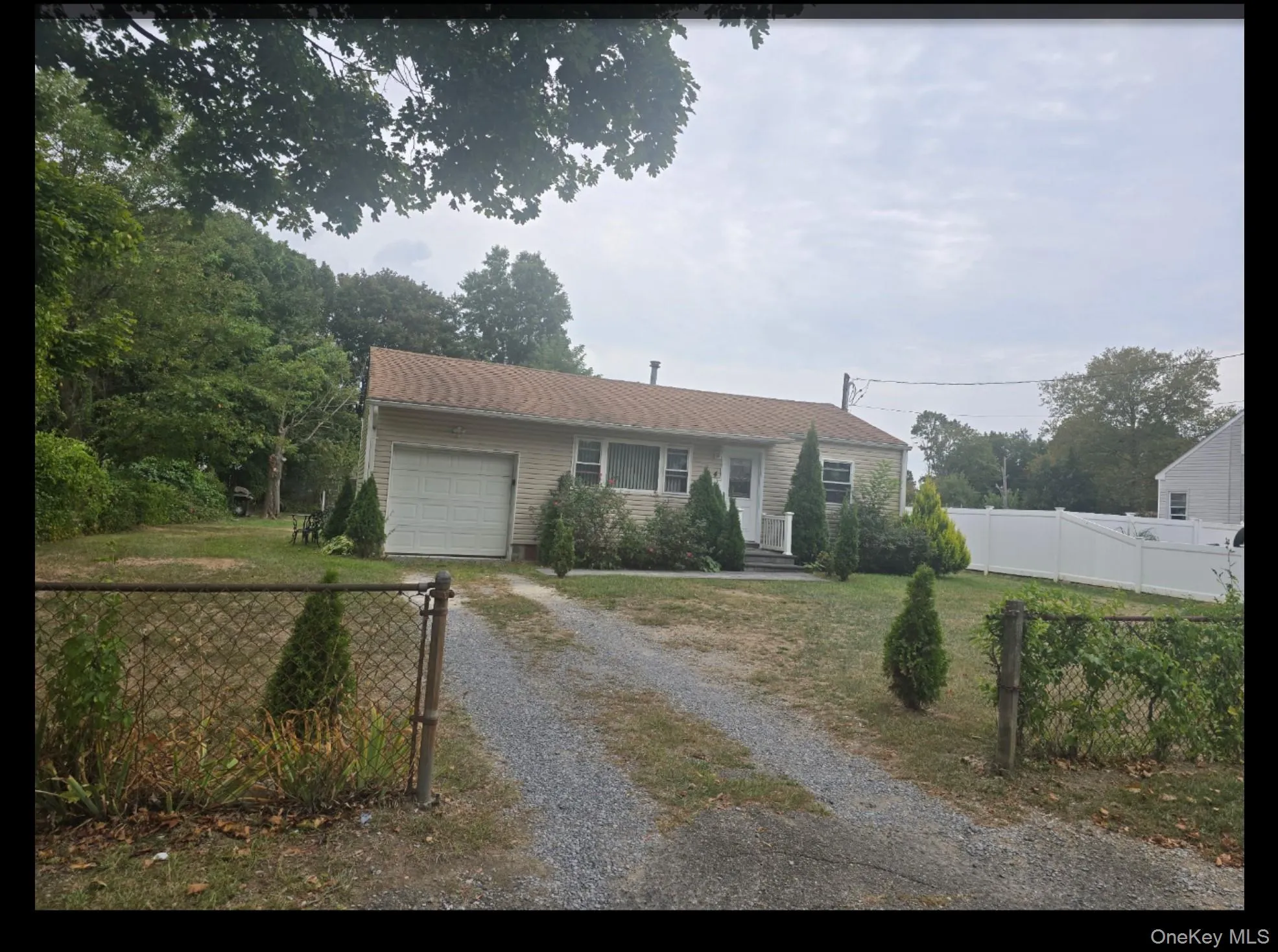 Single story home featuring driveway and an attached garage Single story home featuring driveway and an attached garage