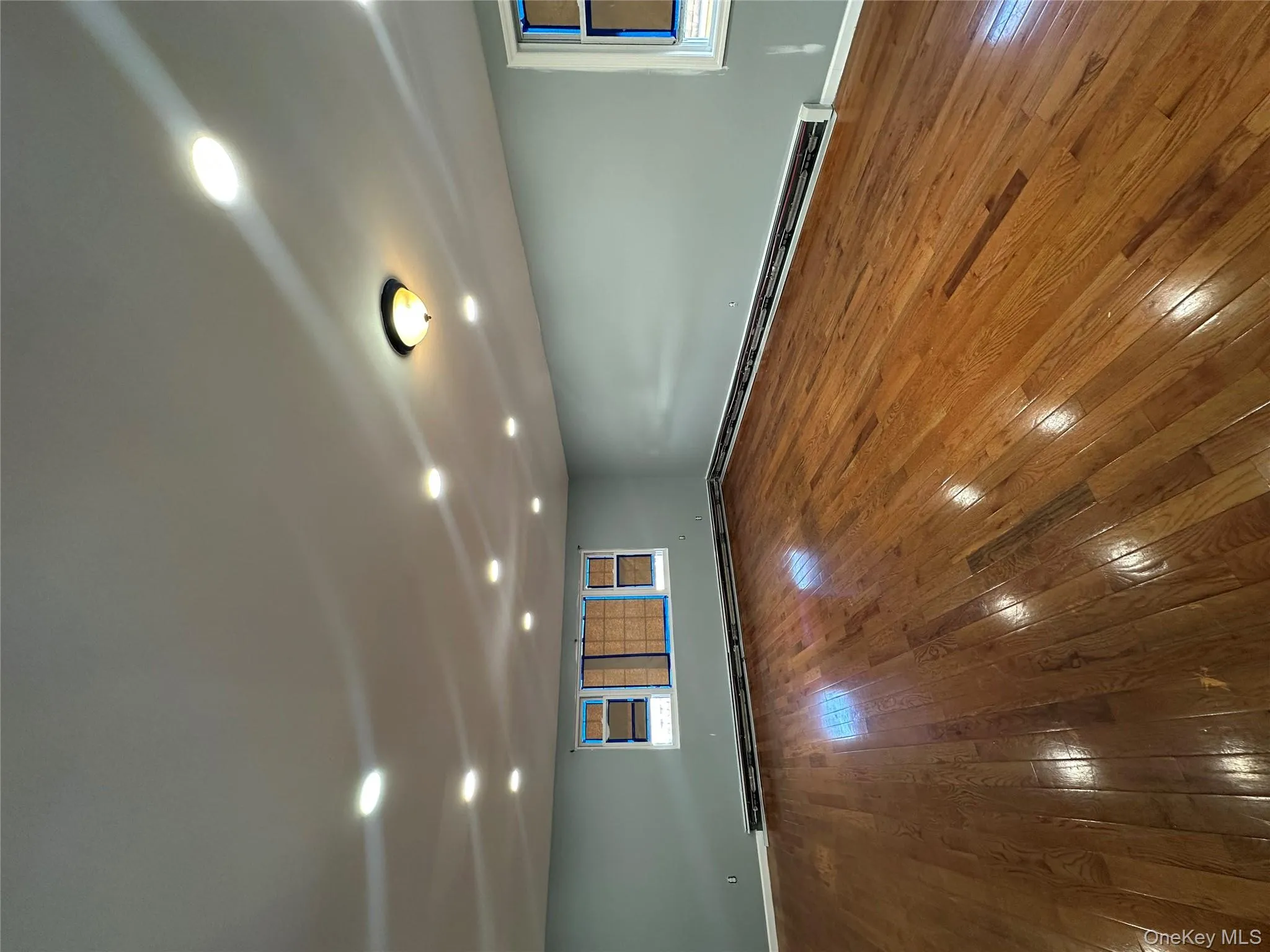 Unfurnished room with dark wood-style floors, healthy amount of natural light, baseboard heating, and recessed lighting Unfurnished room with dark wood-style floors, healthy amount of natural light, baseboard heating, and recessed lighting
