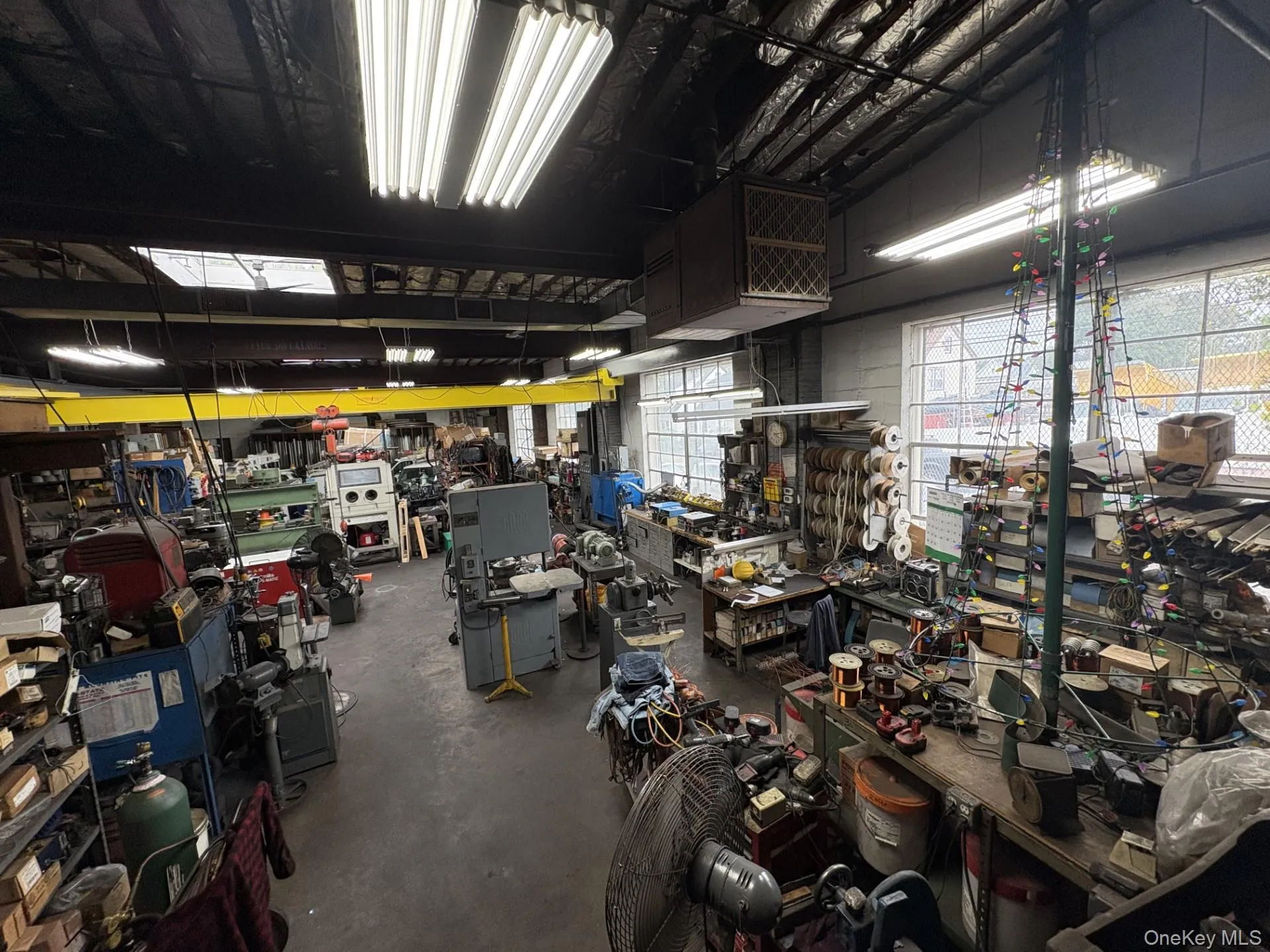 Garage featuring a heating unit and a workshop area Garage featuring a heating unit and a workshop area