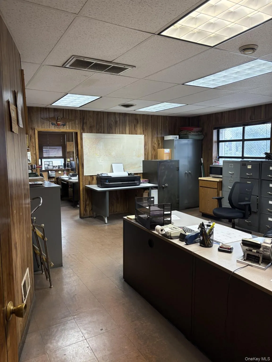 Office area with wooden walls and a drop ceiling Office area with wooden walls and a drop ceiling