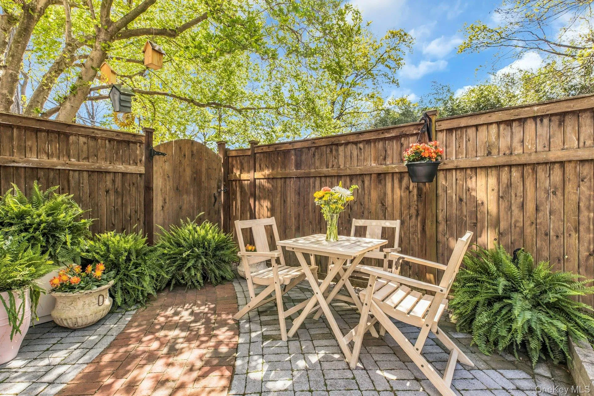 View of patio featuring fence, a gate, and outdoor dining space View of patio featuring fence, a gate, and outdoor dining space