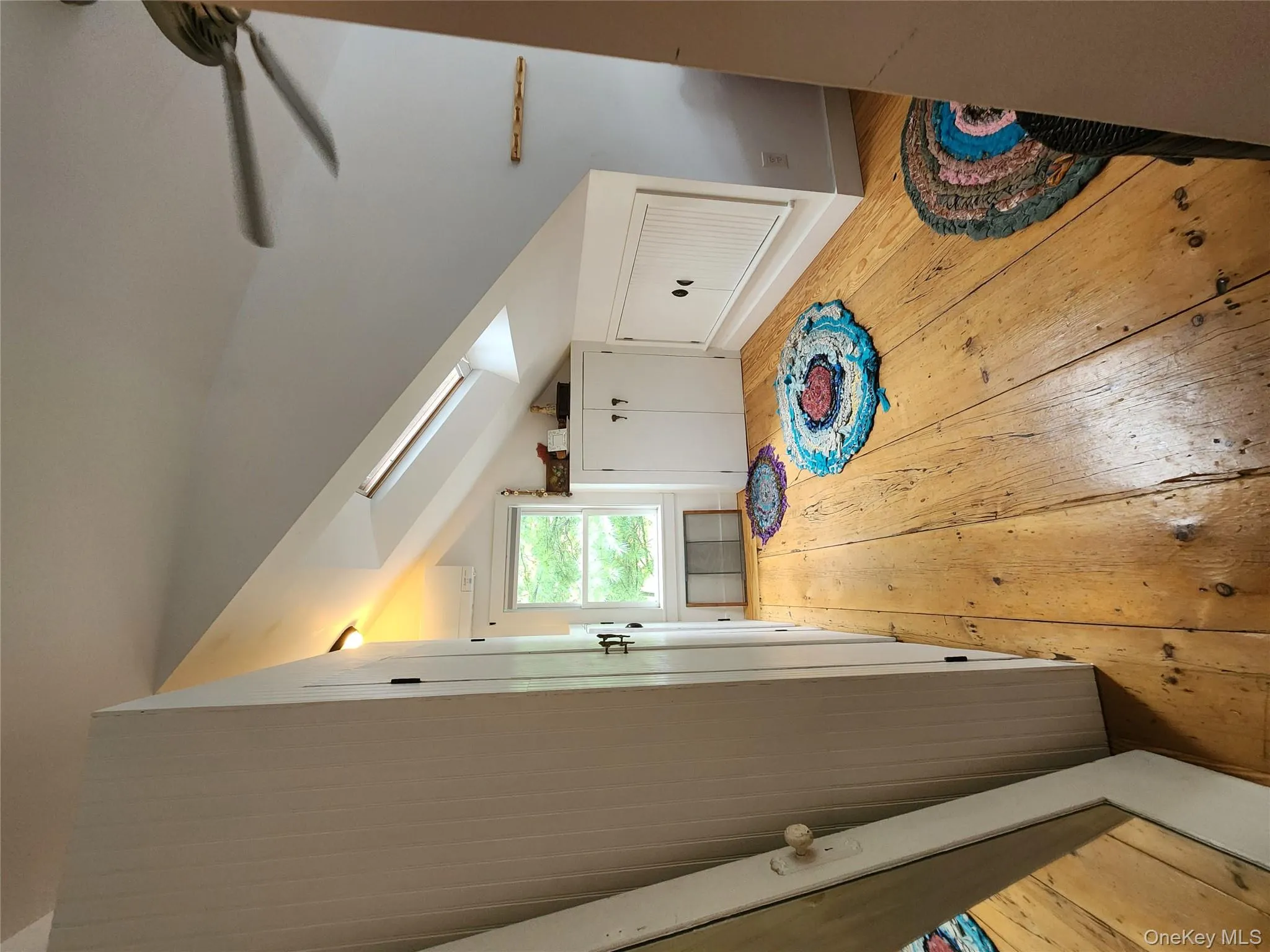 Additional living space with light wood finished floors, a skylight, and vaulted ceiling Additional living space with light wood finished floors, a skylight, and vaulted ceiling