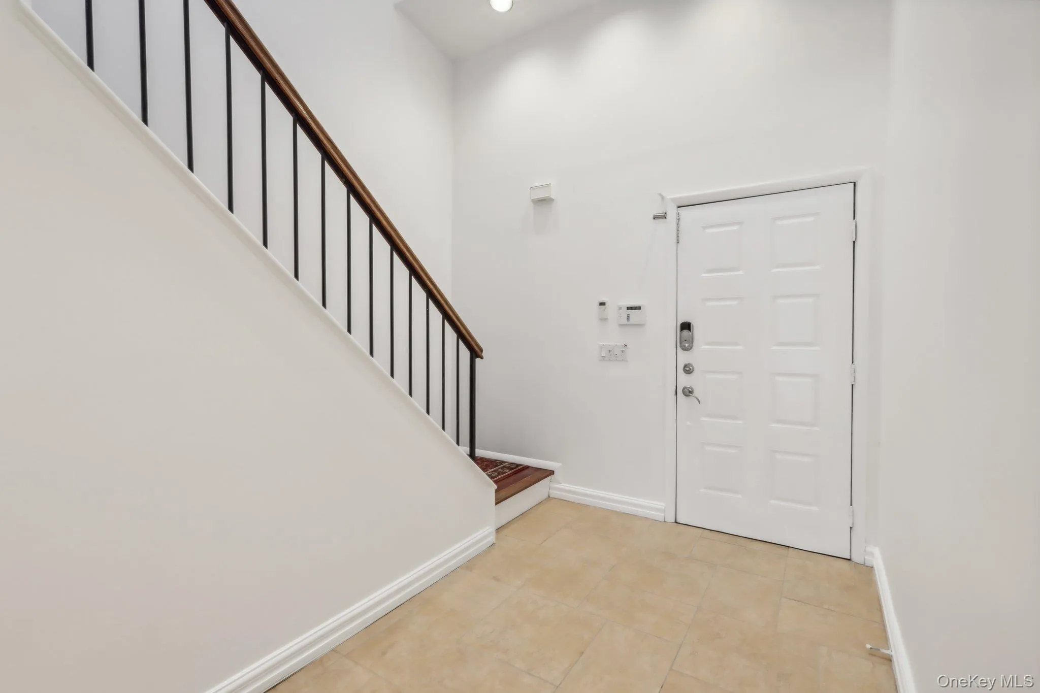 Entryway featuring stairway and light tile patterned flooring Entryway featuring stairway and light tile patterned flooring
