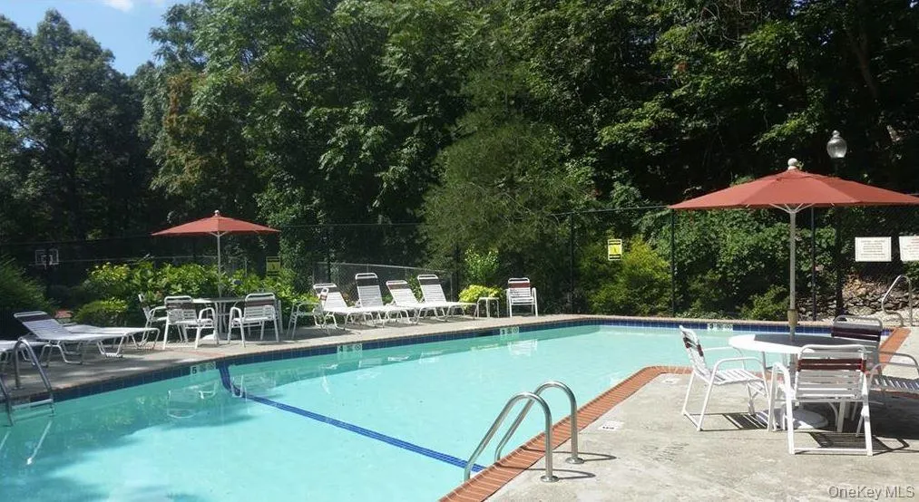 Community pool with a patio area Community pool with a patio area