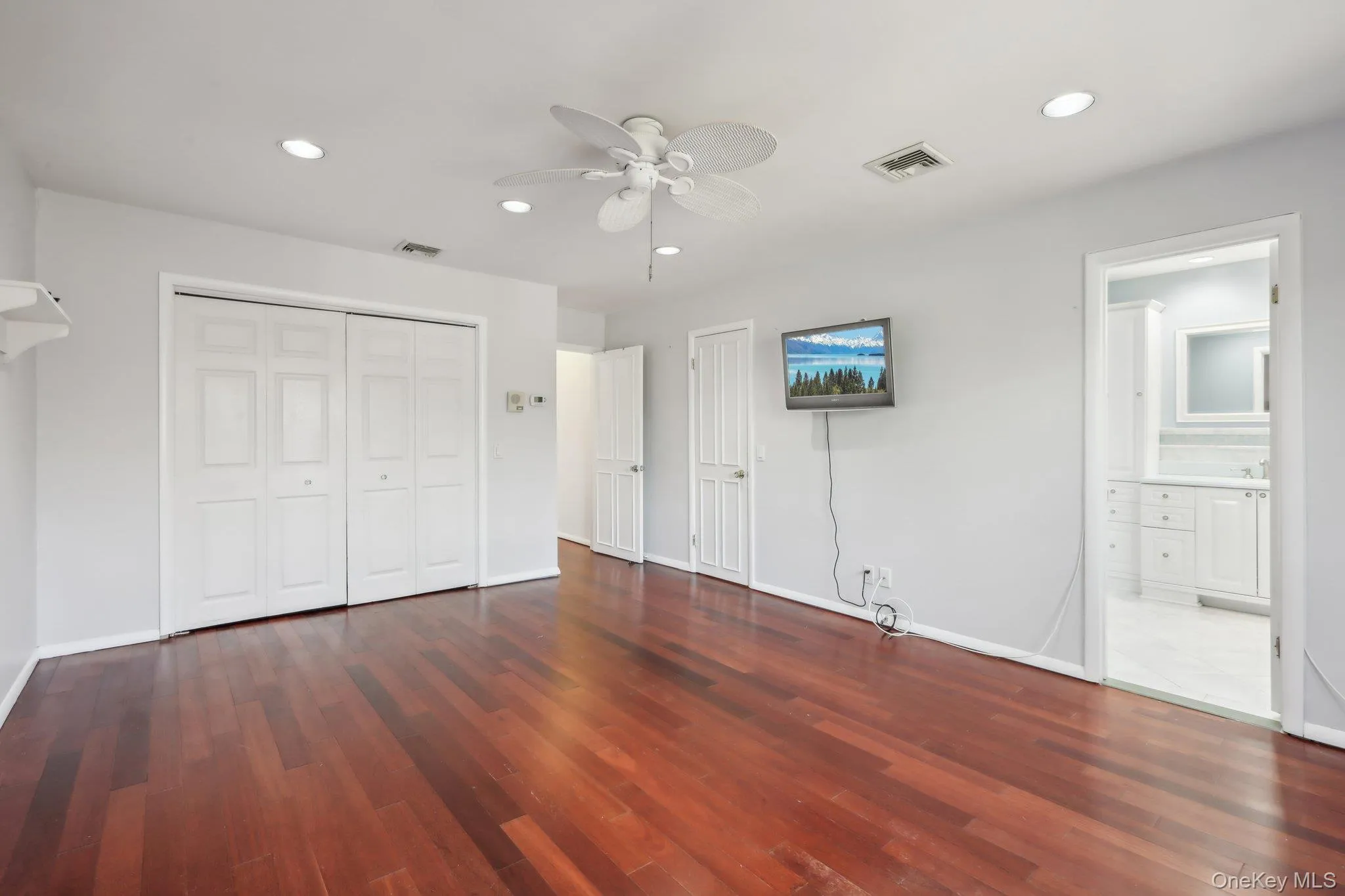 Unfurnished bedroom featuring recessed lighting, dark wood-style floors, ensuite bathroom, a closet, and ceiling fan Unfurnished bedroom featuring recessed lighting, dark wood-style floors, ensuite bathroom, a closet, and ceiling fan