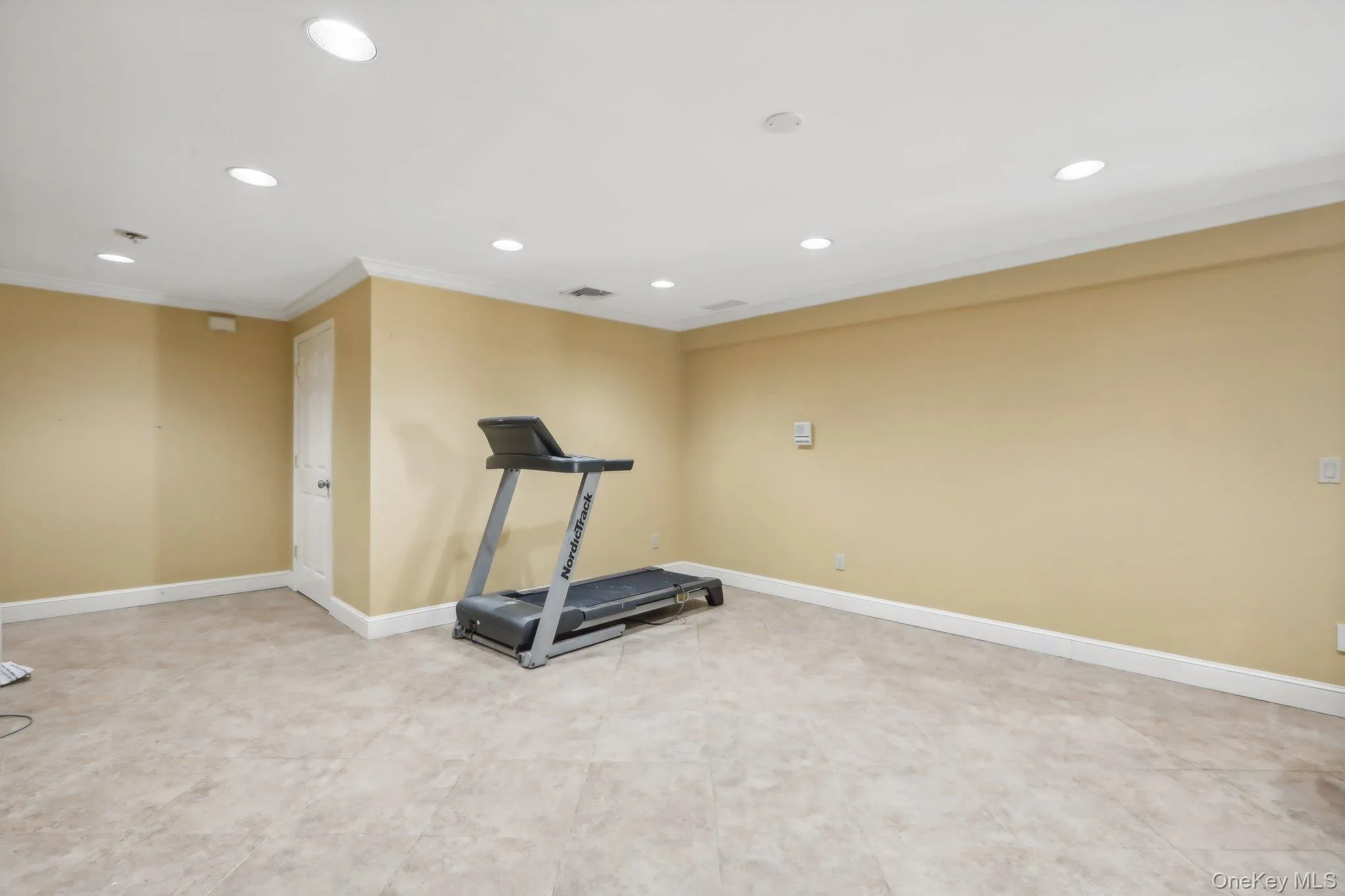Workout area featuring recessed lighting and ornamental molding Workout area featuring recessed lighting and ornamental molding