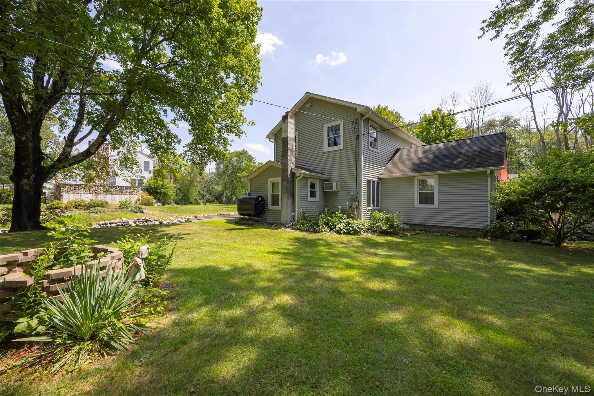 Rear view of property featuring a lawn Rear view of property featuring a lawn