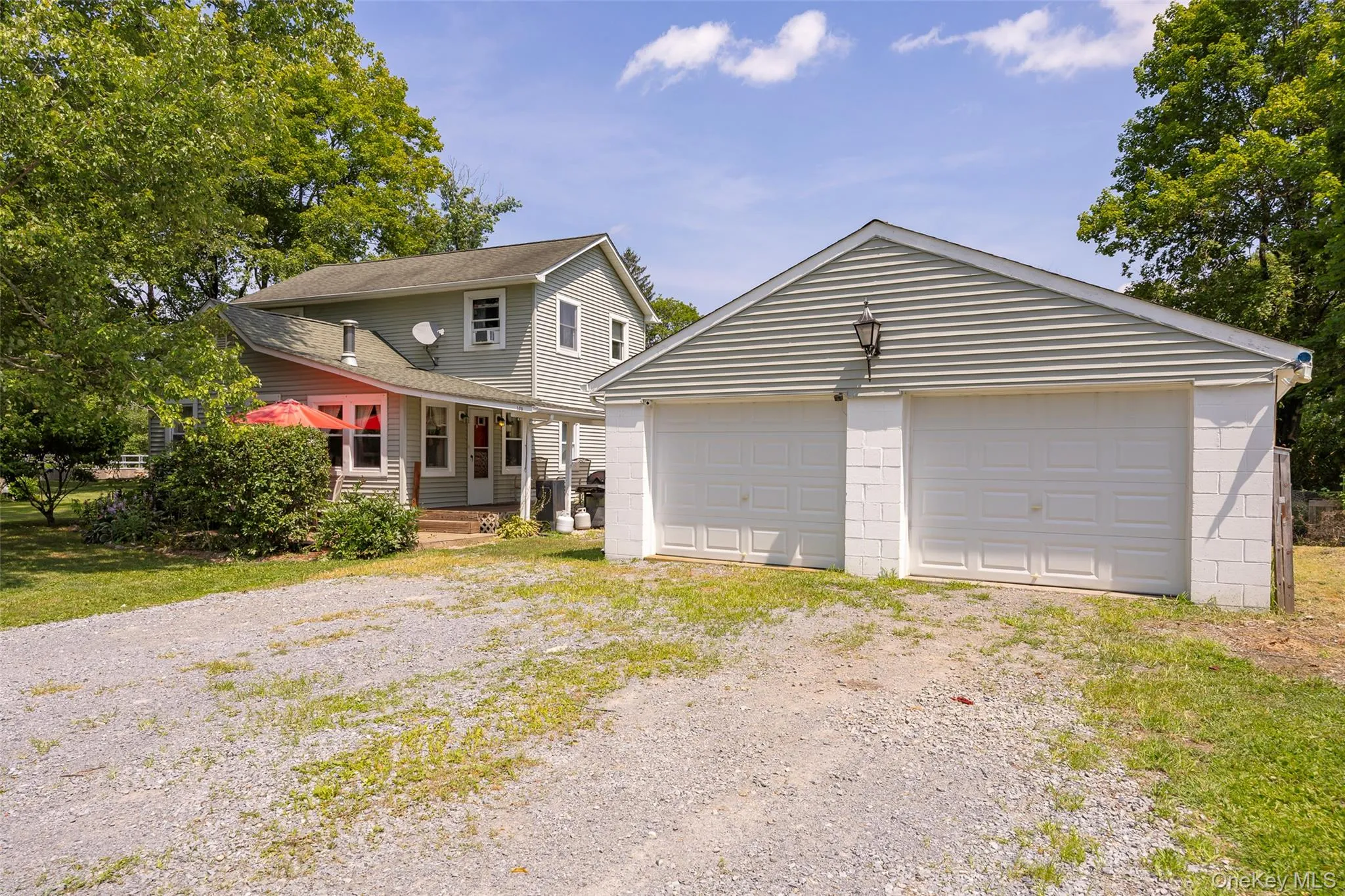 View of front of property with a garage and an outdoor structure View of front of property with a garage and an outdoor structure