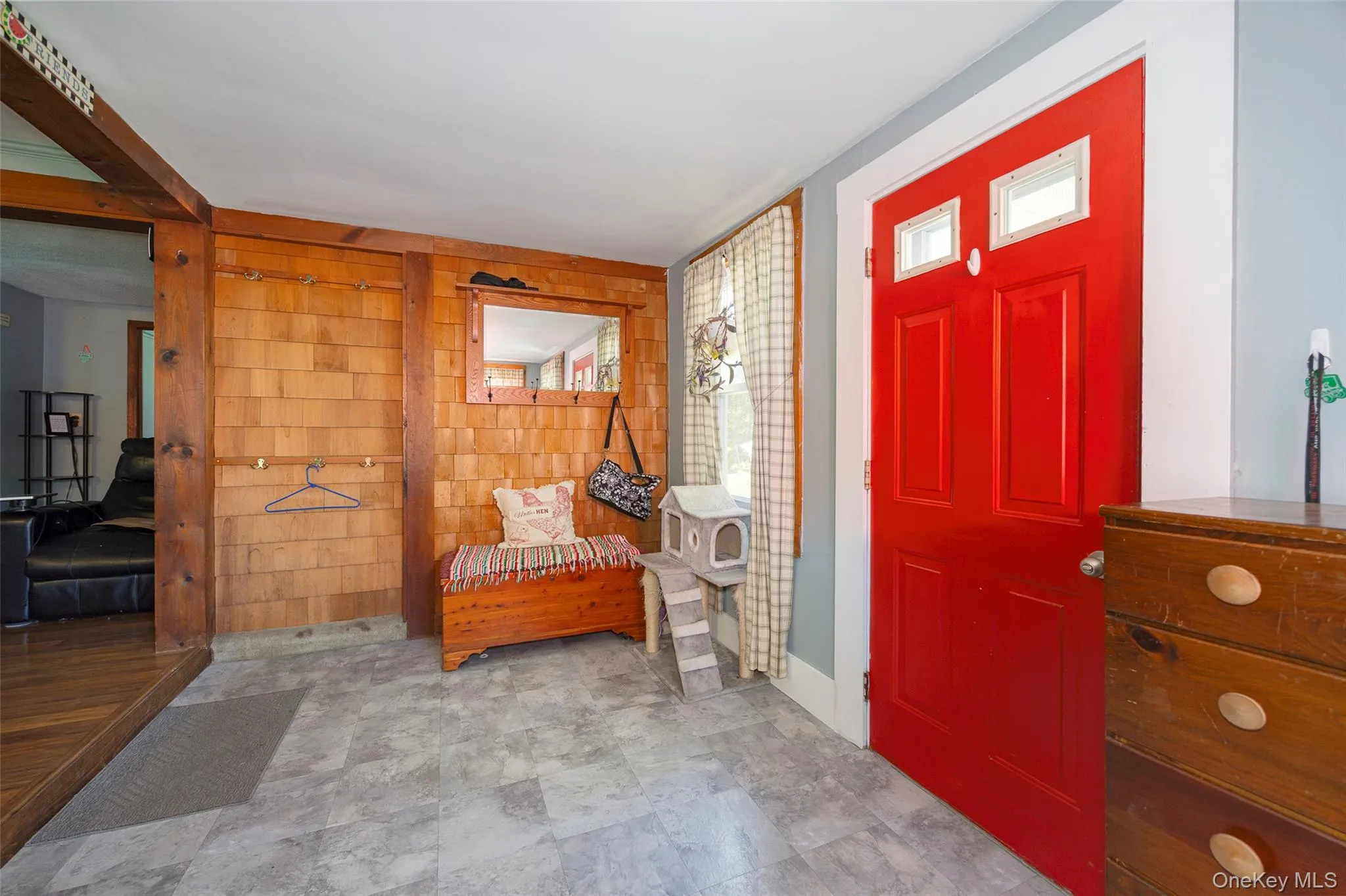 Entryway featuring wooden walls and plenty of natural light Entryway featuring wooden walls and plenty of natural light