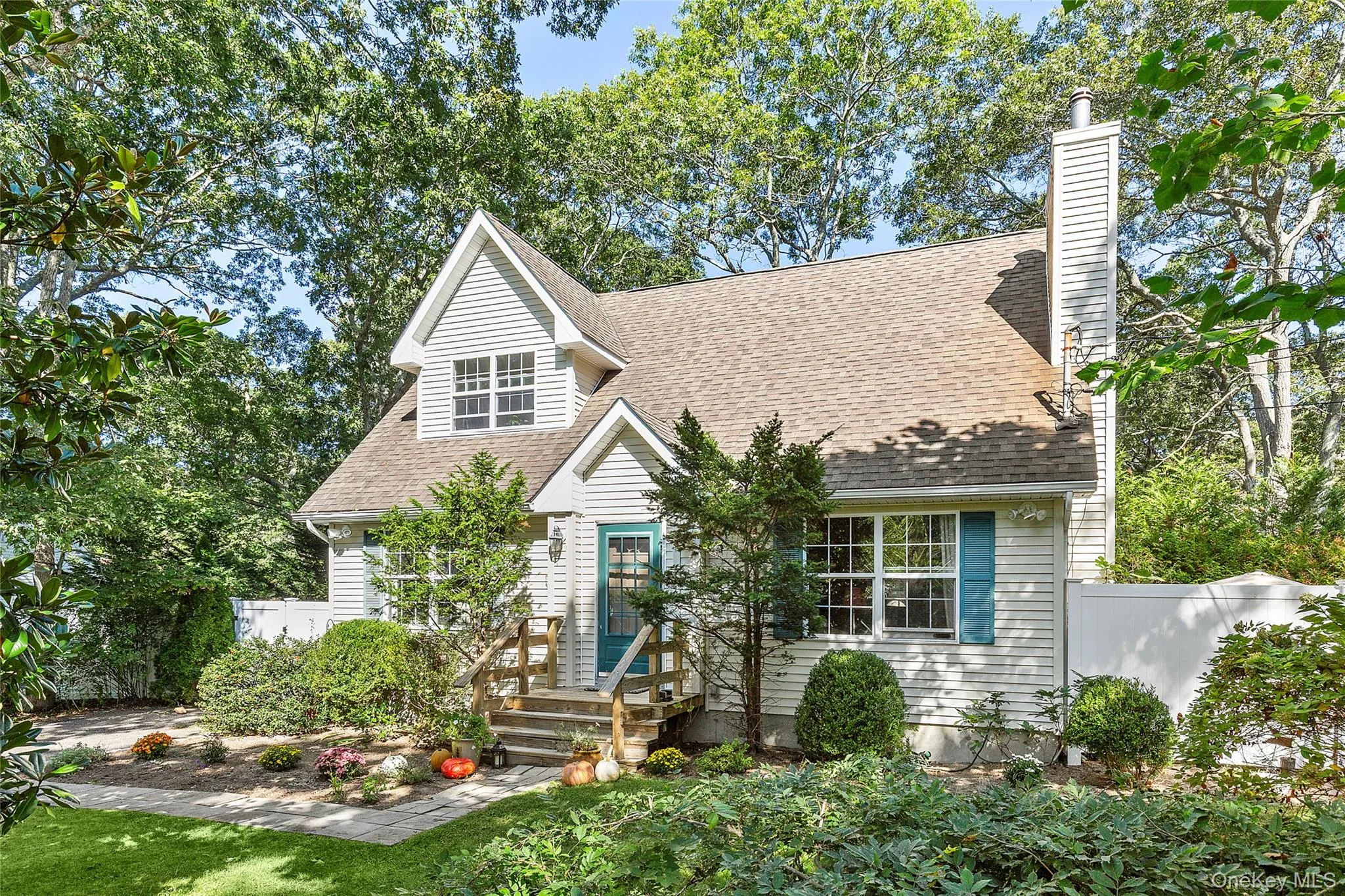 Cape cod-style house with roof with shingles and a chimney Cape cod-style house with roof with shingles and a chimney
