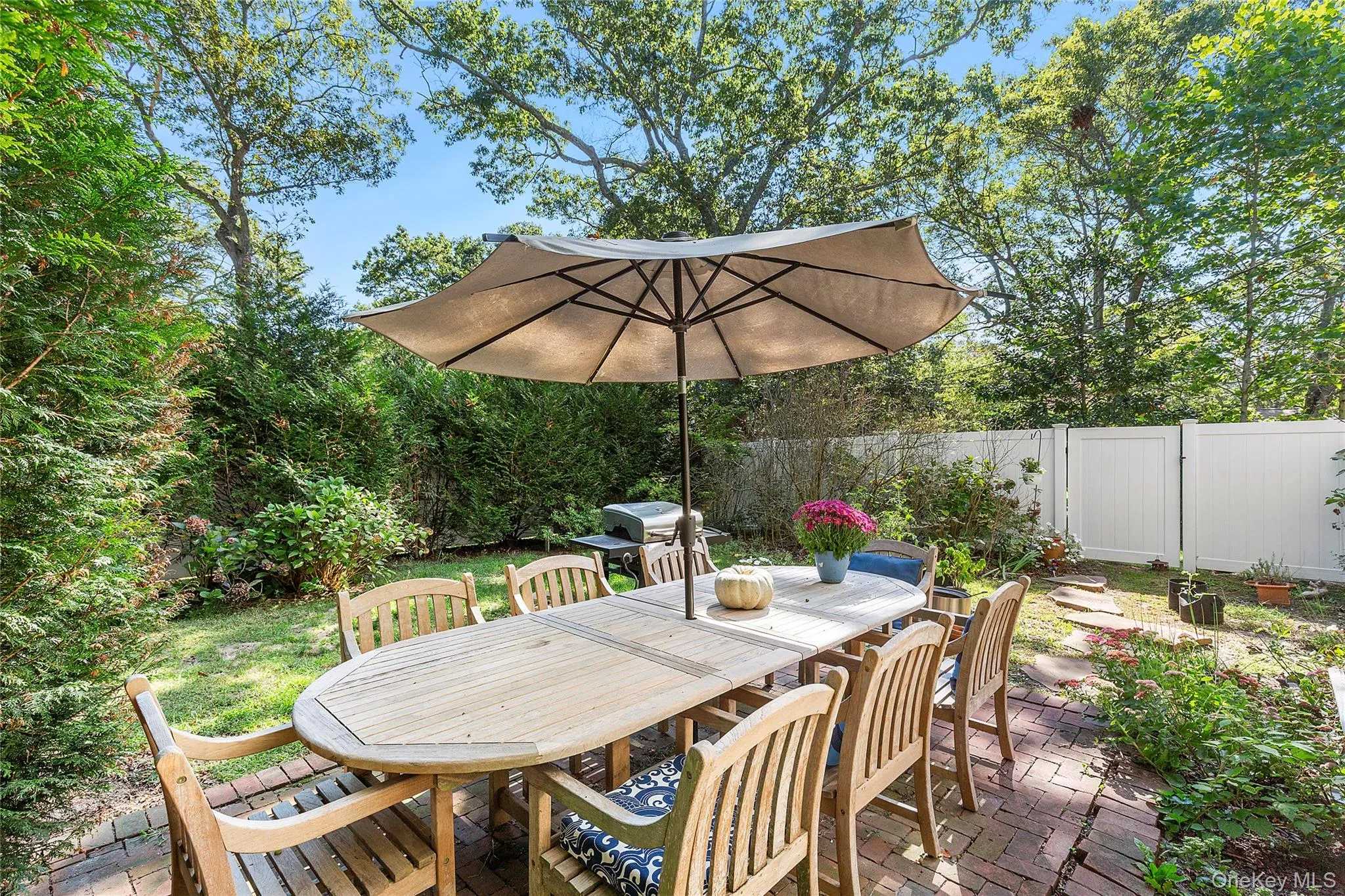 Wooden deck featuring outdoor dining space, a fenced backyard, a patio area, and grilling area Wooden deck featuring outdoor dining space, a fenced backyard, a patio area, and grilling area