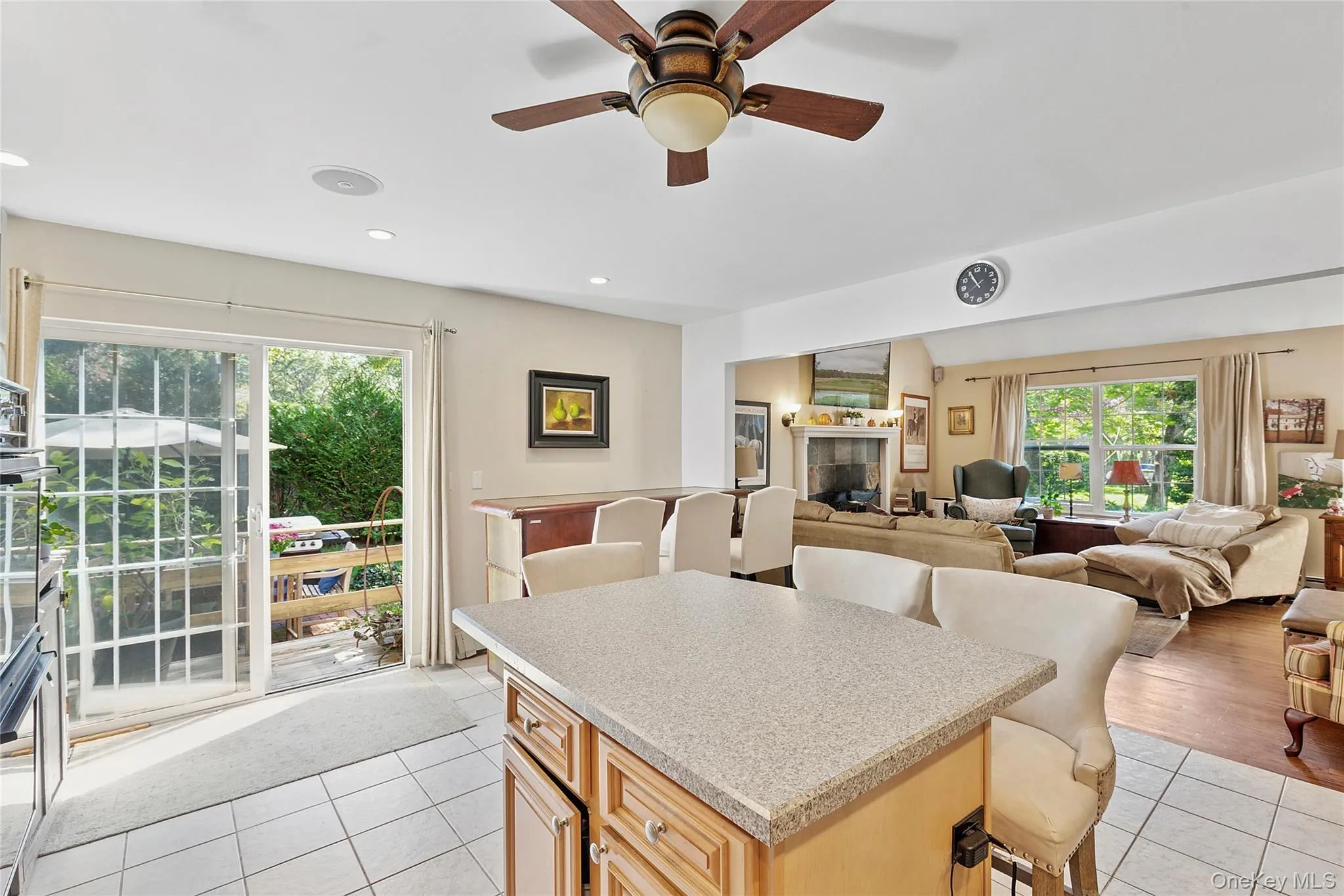 Kitchen with light tile patterned flooring, light brown cabinetry, recessed lighting, a breakfast bar, and ceiling fan Kitchen with light tile patterned flooring, light brown cabinetry, recessed lighting, a breakfast bar, and ceiling fan