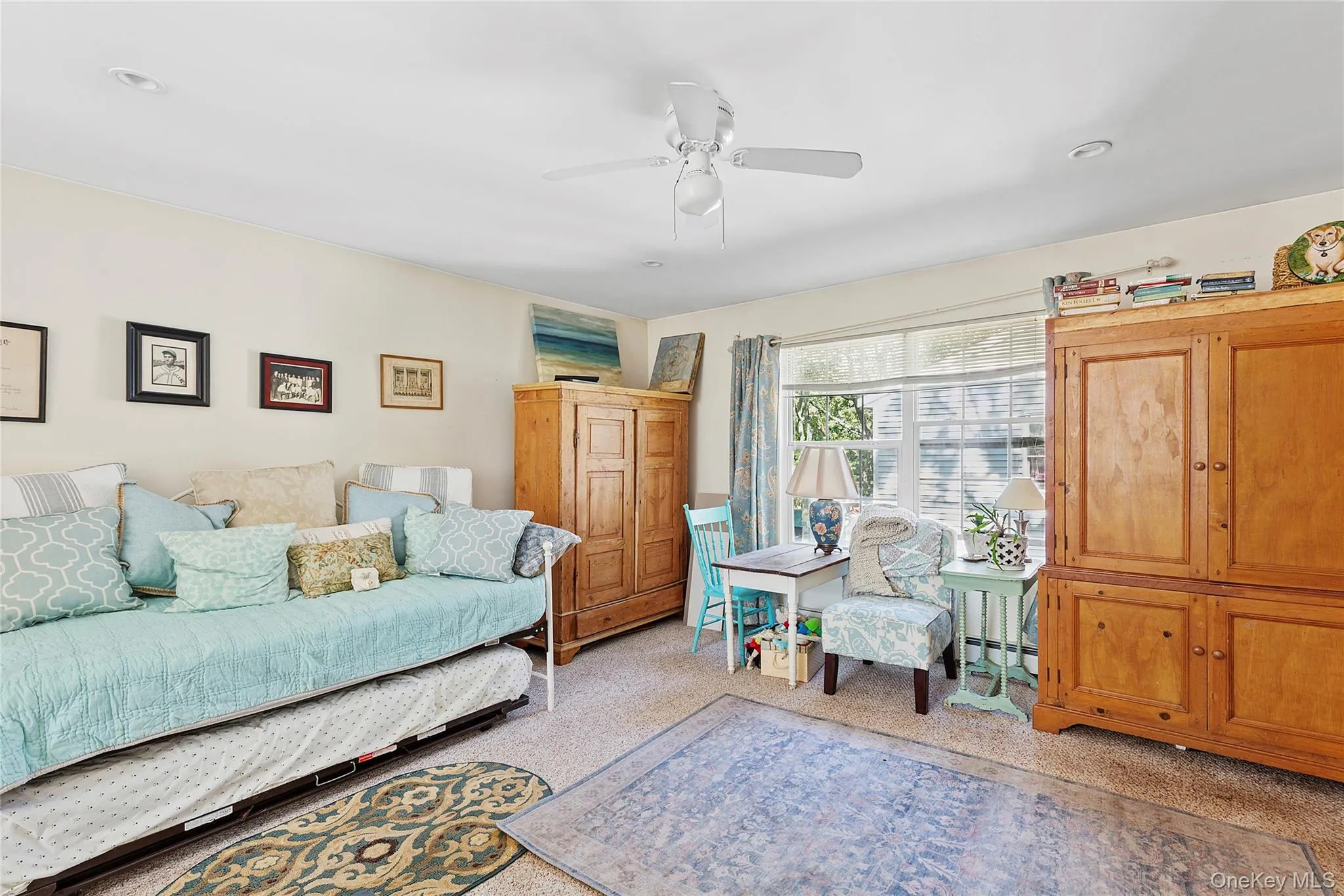 Living area with carpet, a baseboard heating unit, ceiling fan, and recessed lighting Living area with carpet, a baseboard heating unit, ceiling fan, and recessed lighting