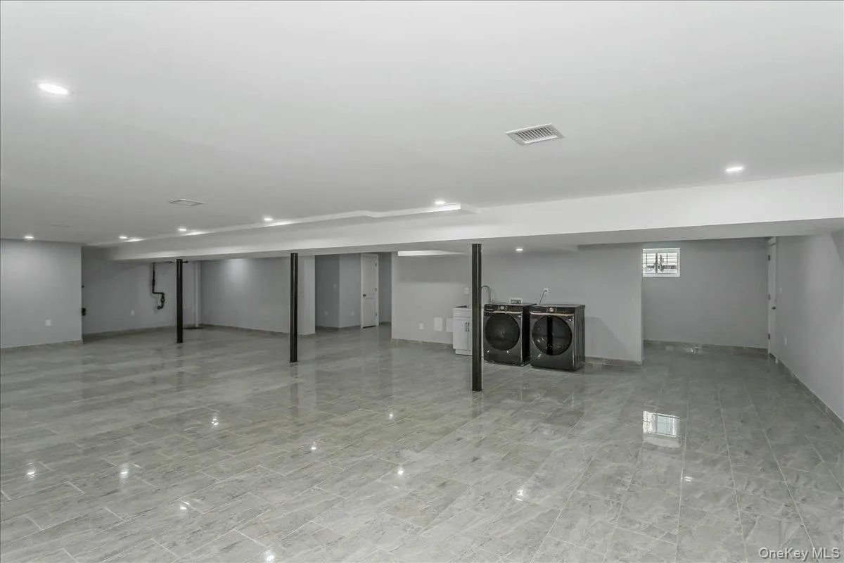 Basement with independent washer and dryer and recessed lighting Basement with independent washer and dryer and recessed lighting